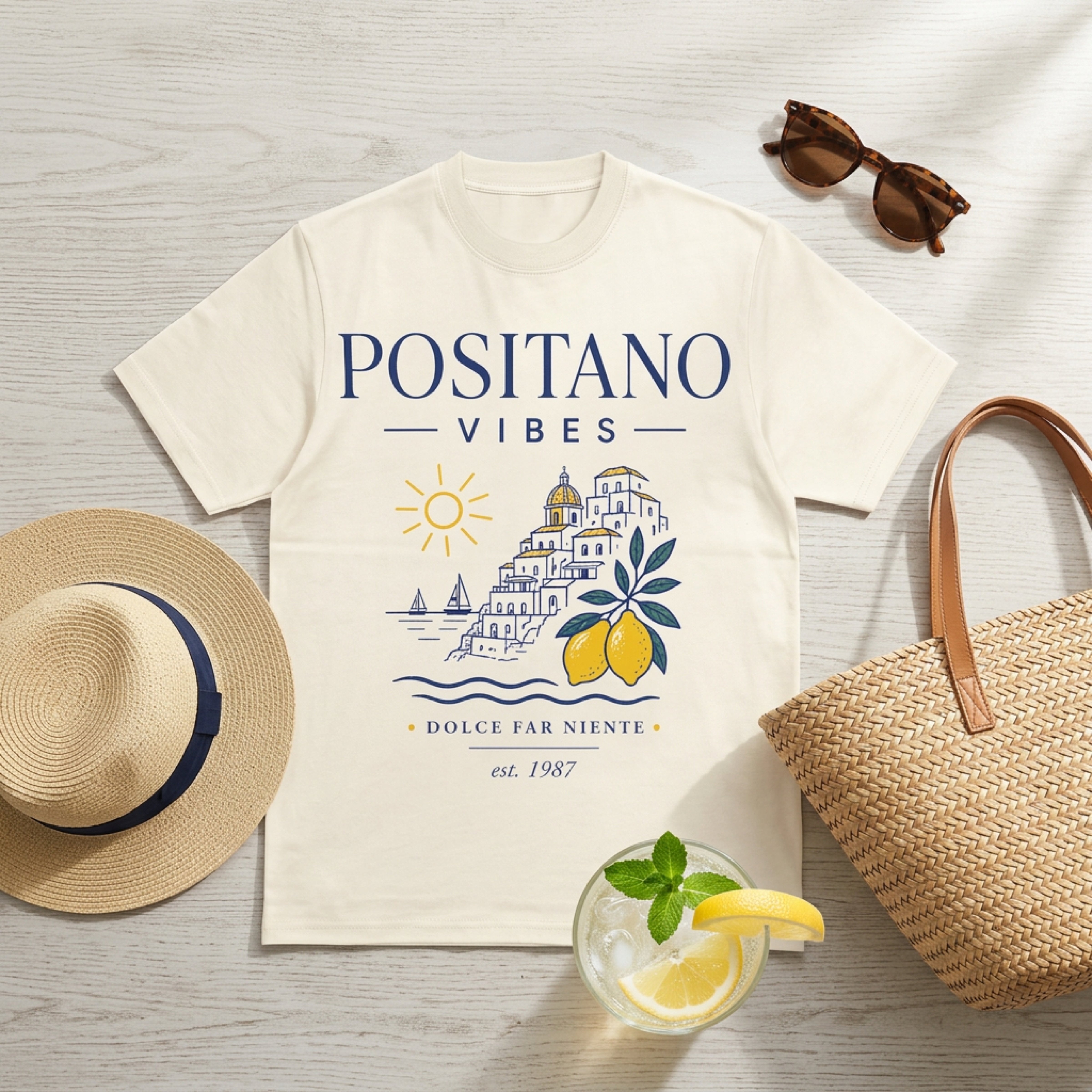 Cream t-shirt with "Positano Vibes" and a sun, buildings, and lemons design.