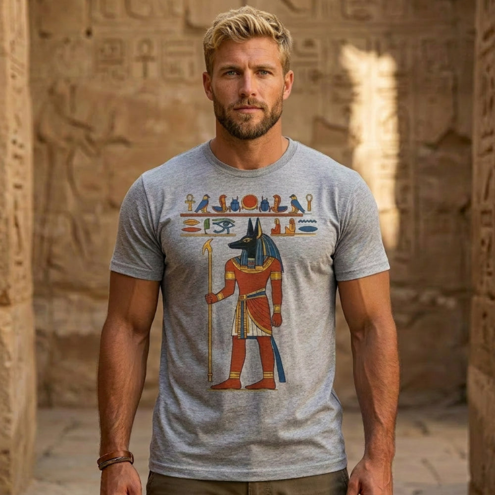 Man wearing grey t-shirt with Egyptian Anubis graphic.