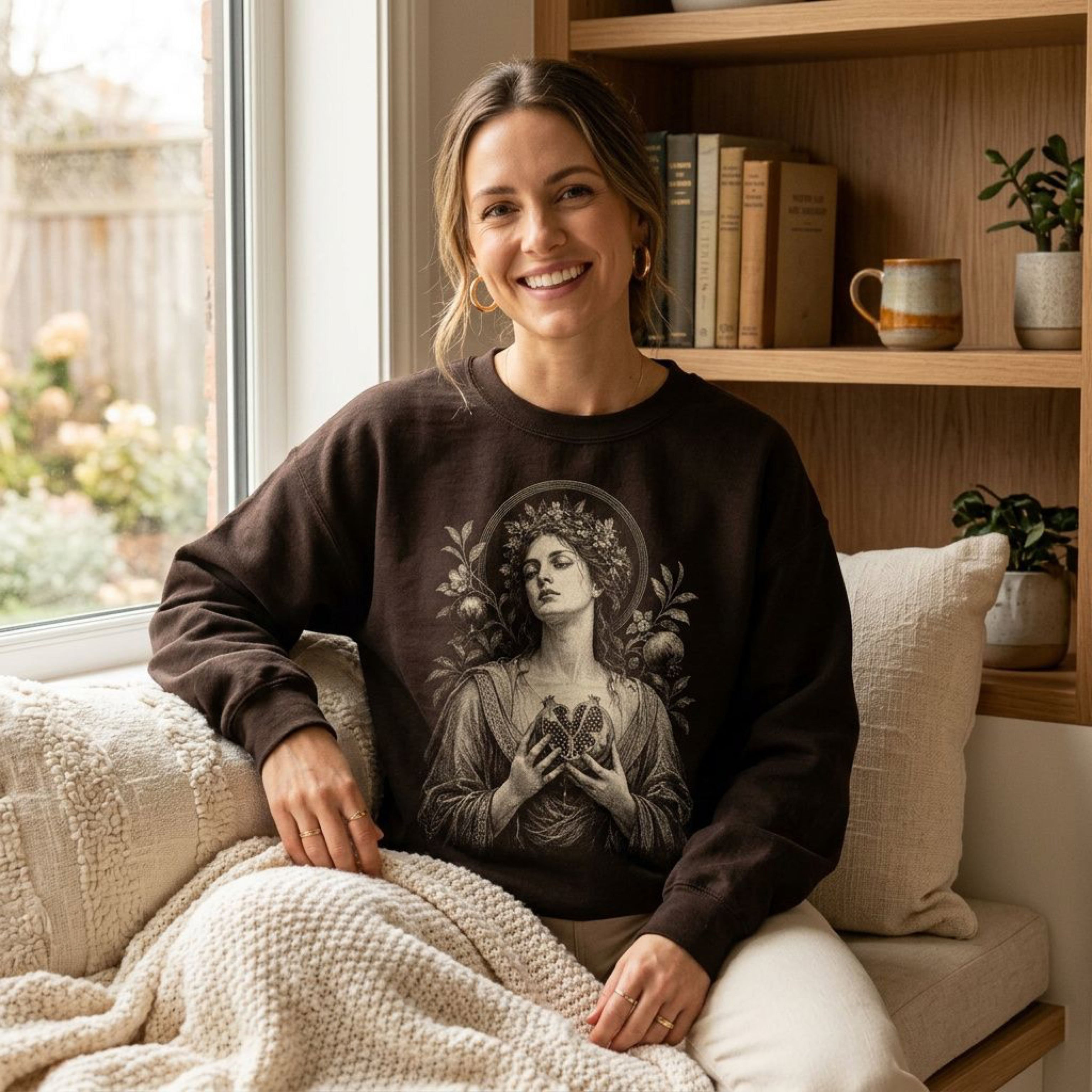 Woman wearing a dark brown sweatshirt with a vintage illustration.