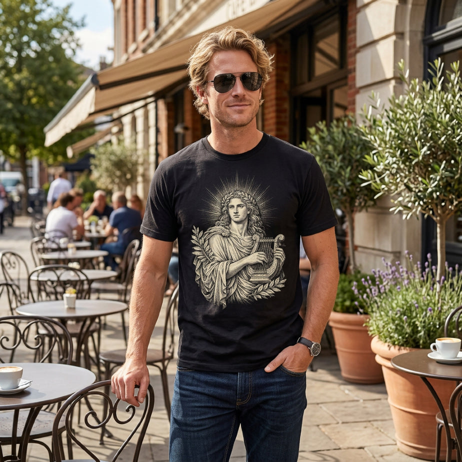 Man wearing black t-shirt with classical illustration and jeans at an outdoor cafe.