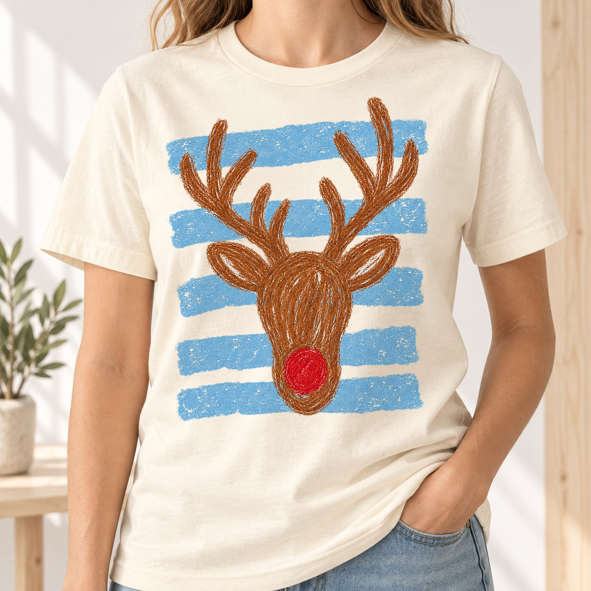 Cream t-shirt with a reindeer graphic and blue horizontal stripes.