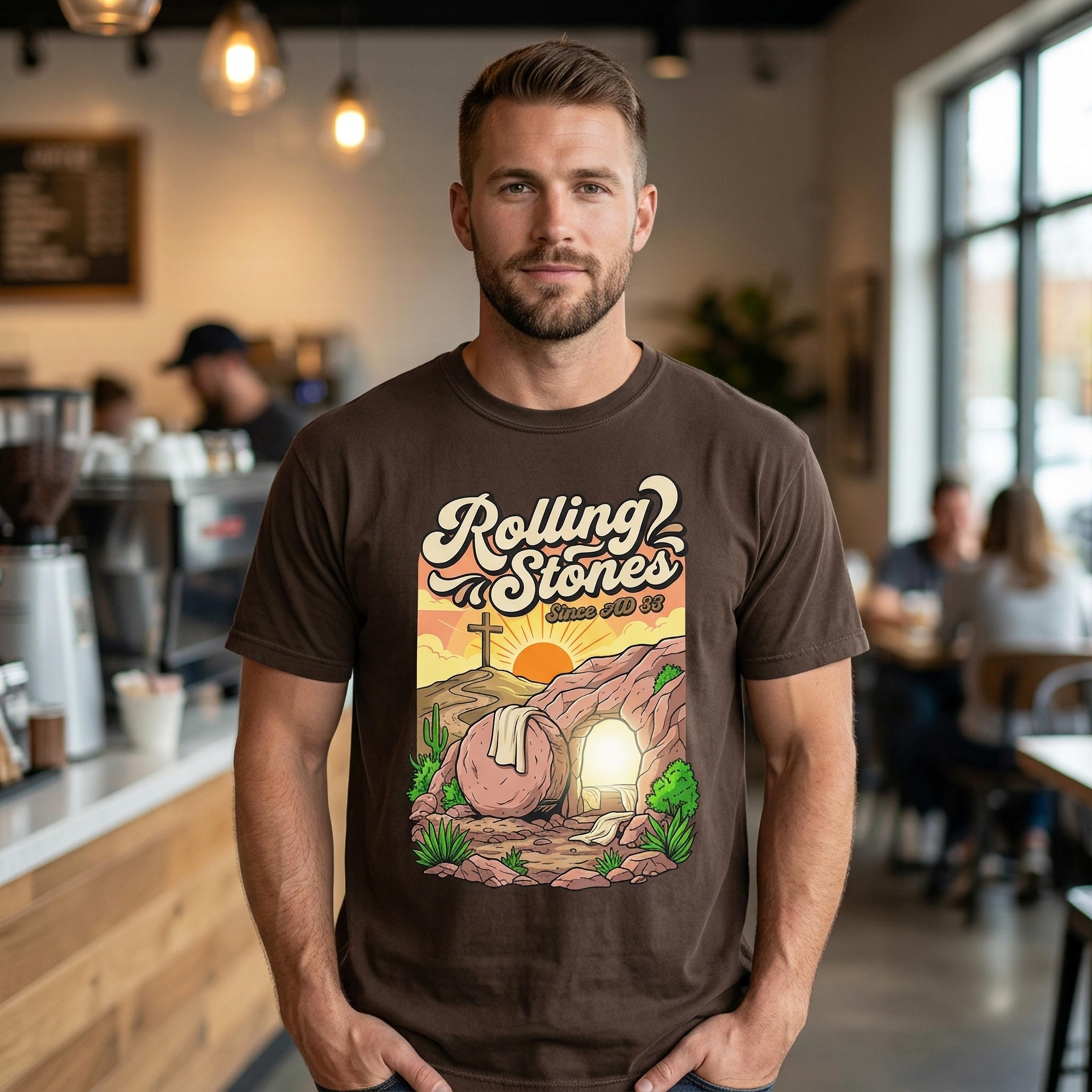 Brown t-shirt with Rolling Stones logo, tomb with rising sun graphic.