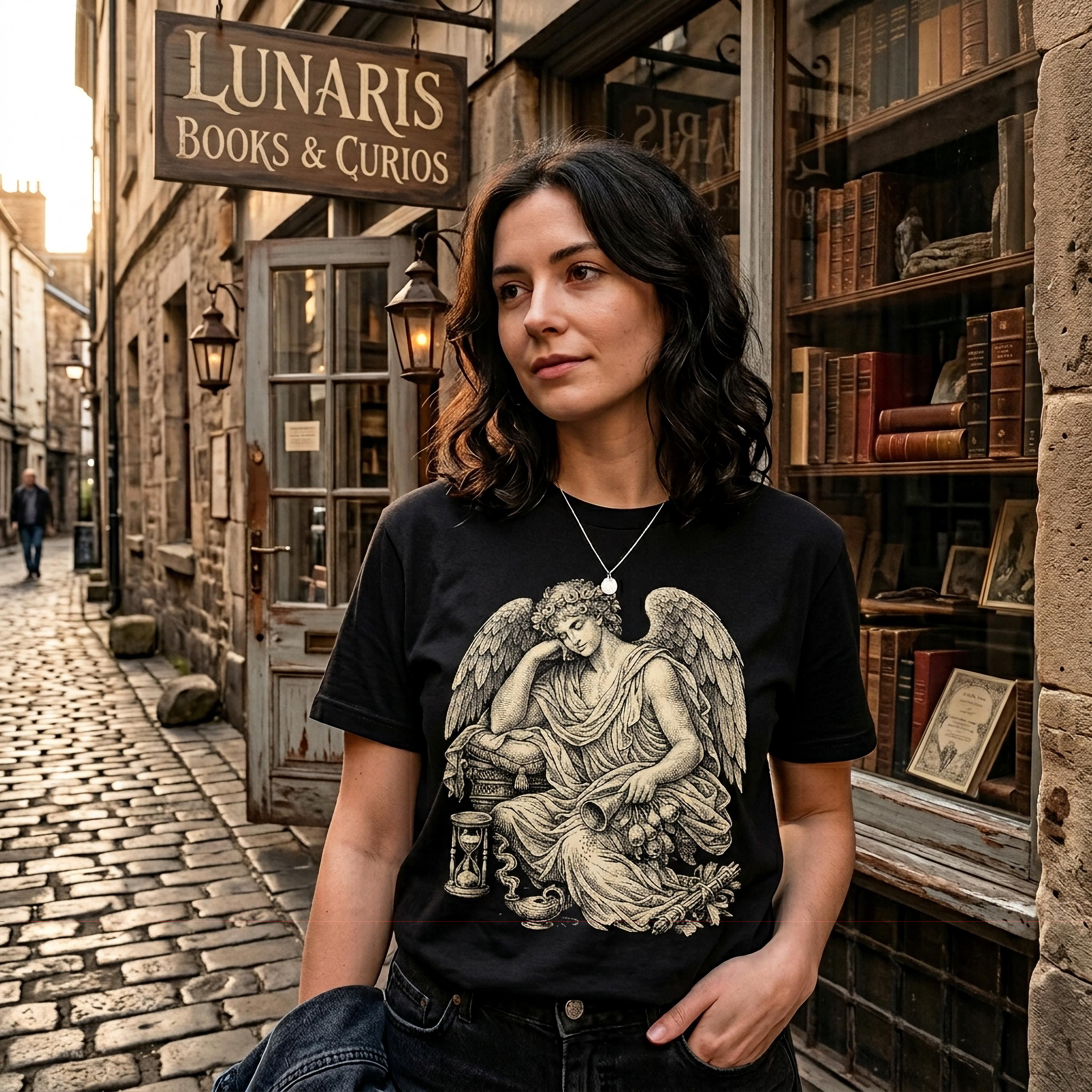 Woman wearing t-shirt with seated angel and hourglass graphic in front of shop.