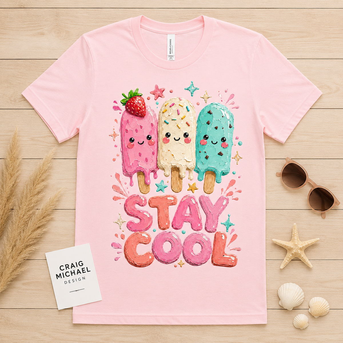 Pink t-shirt with three smiling popsicles and "Stay Cool" text.