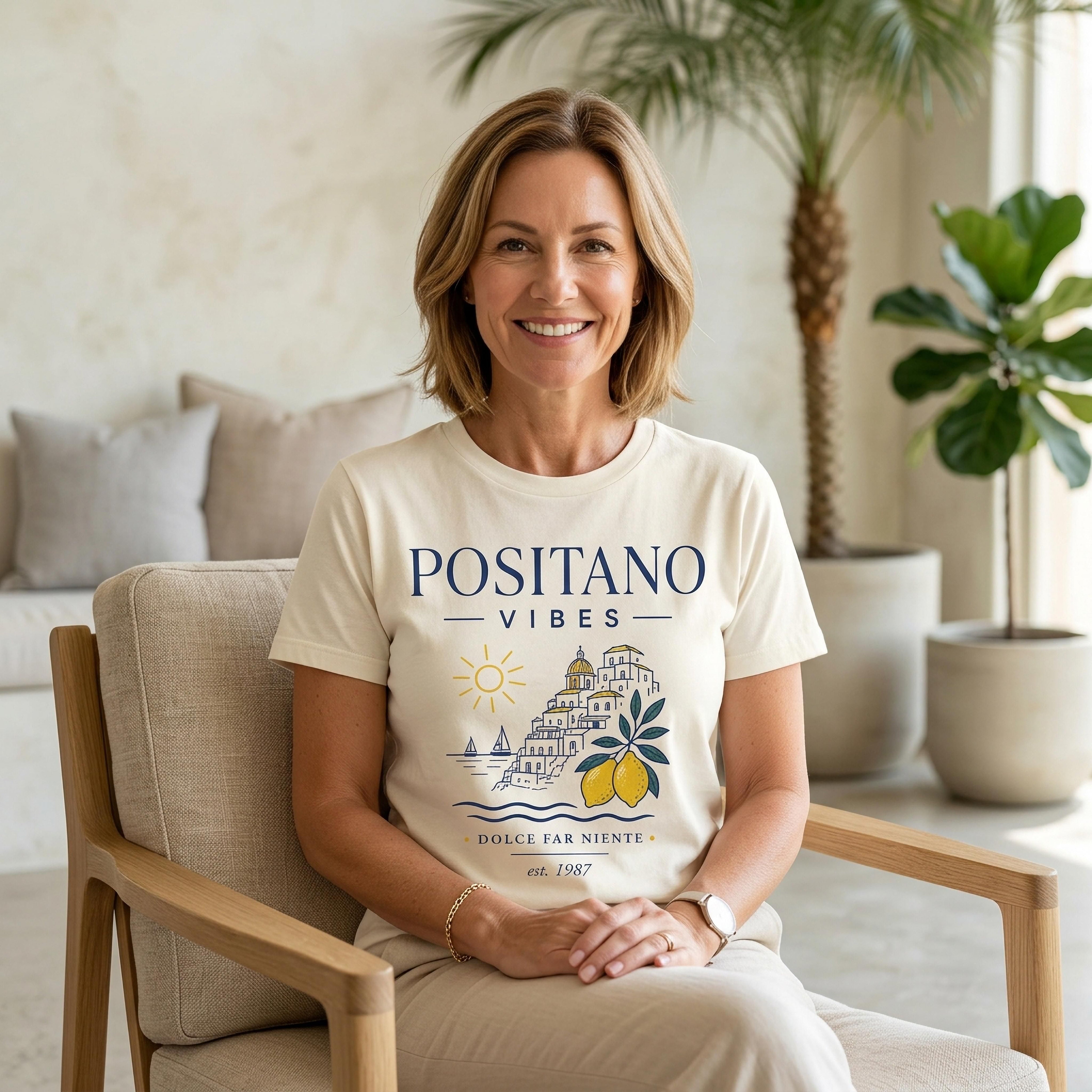 Cream t-shirt with "POSITANO VIBES" text and coastal graphic.