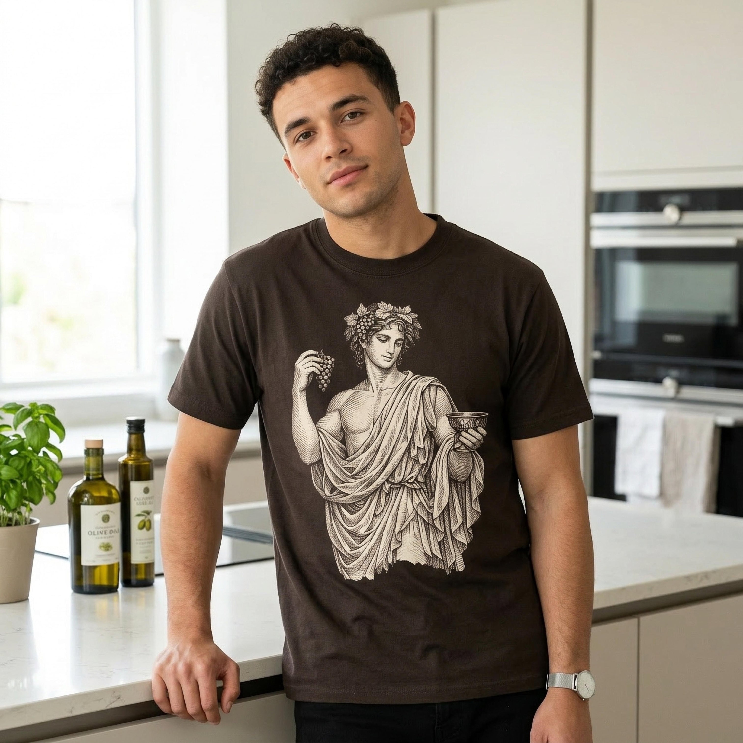 Man wearing dark t-shirt with classical illustration of a figure holding grapes and a bowl.