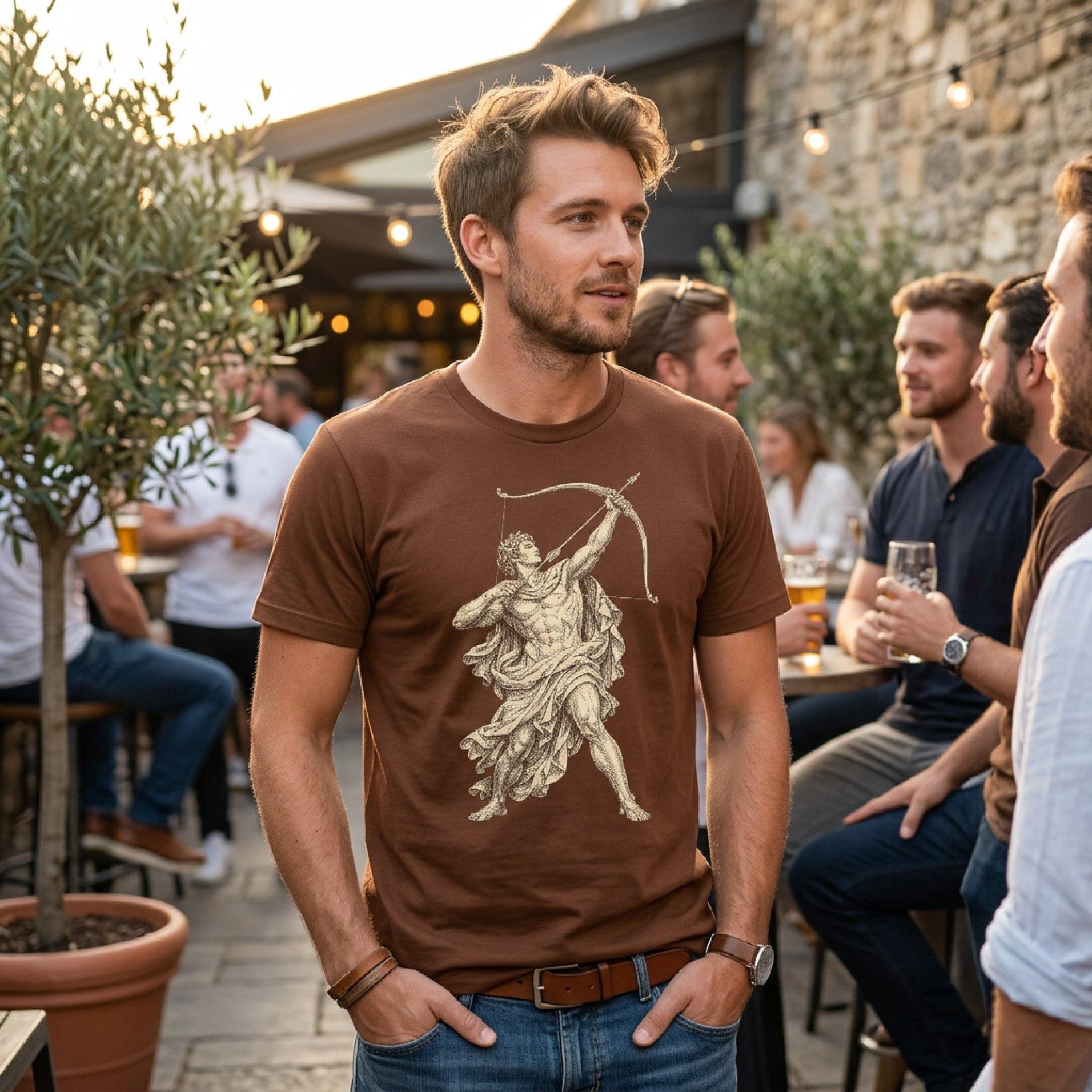 Man wearing brown t-shirt with illustration of an archer.