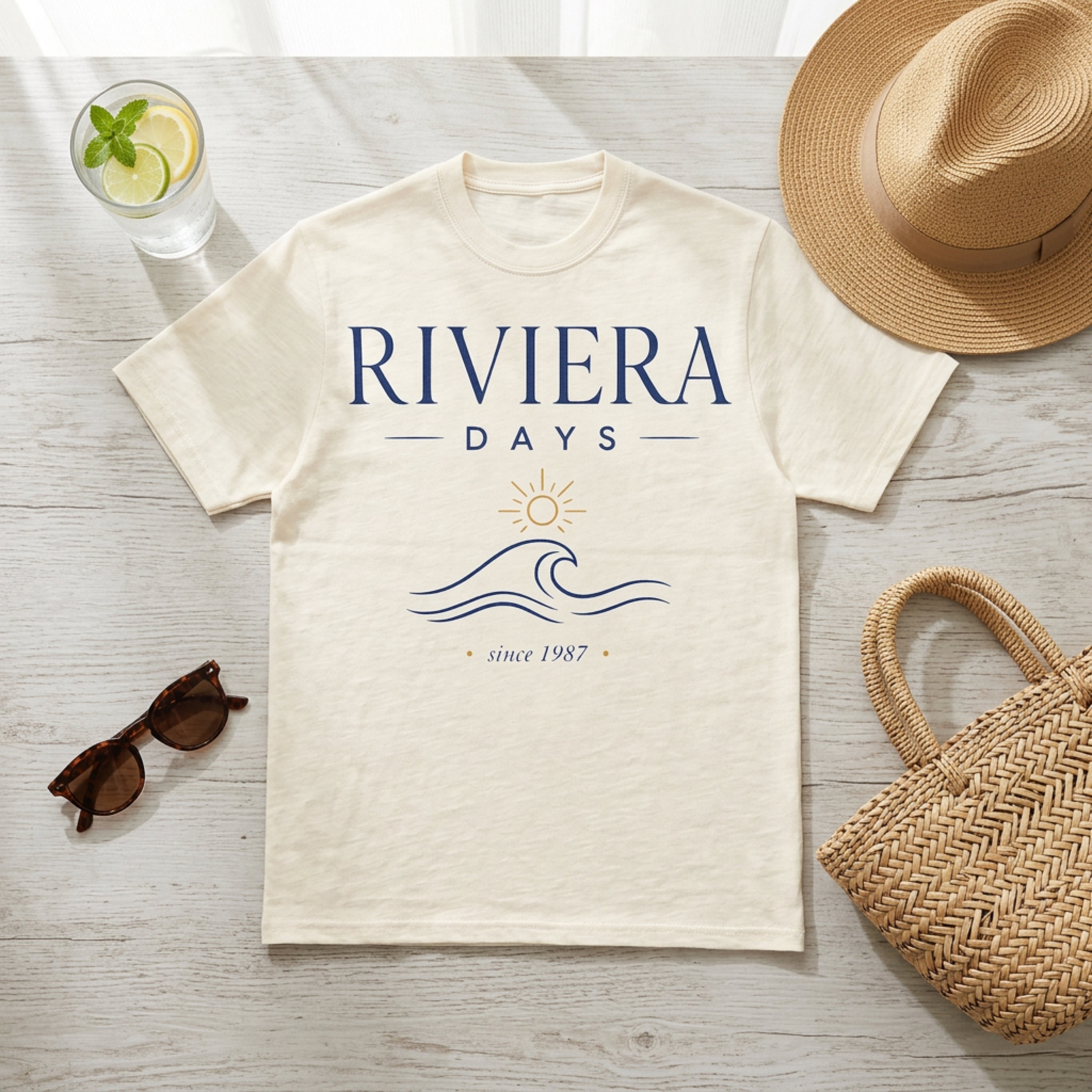 Cream t-shirt with "Riviera Days since 1987" and wavy sun graphic.
