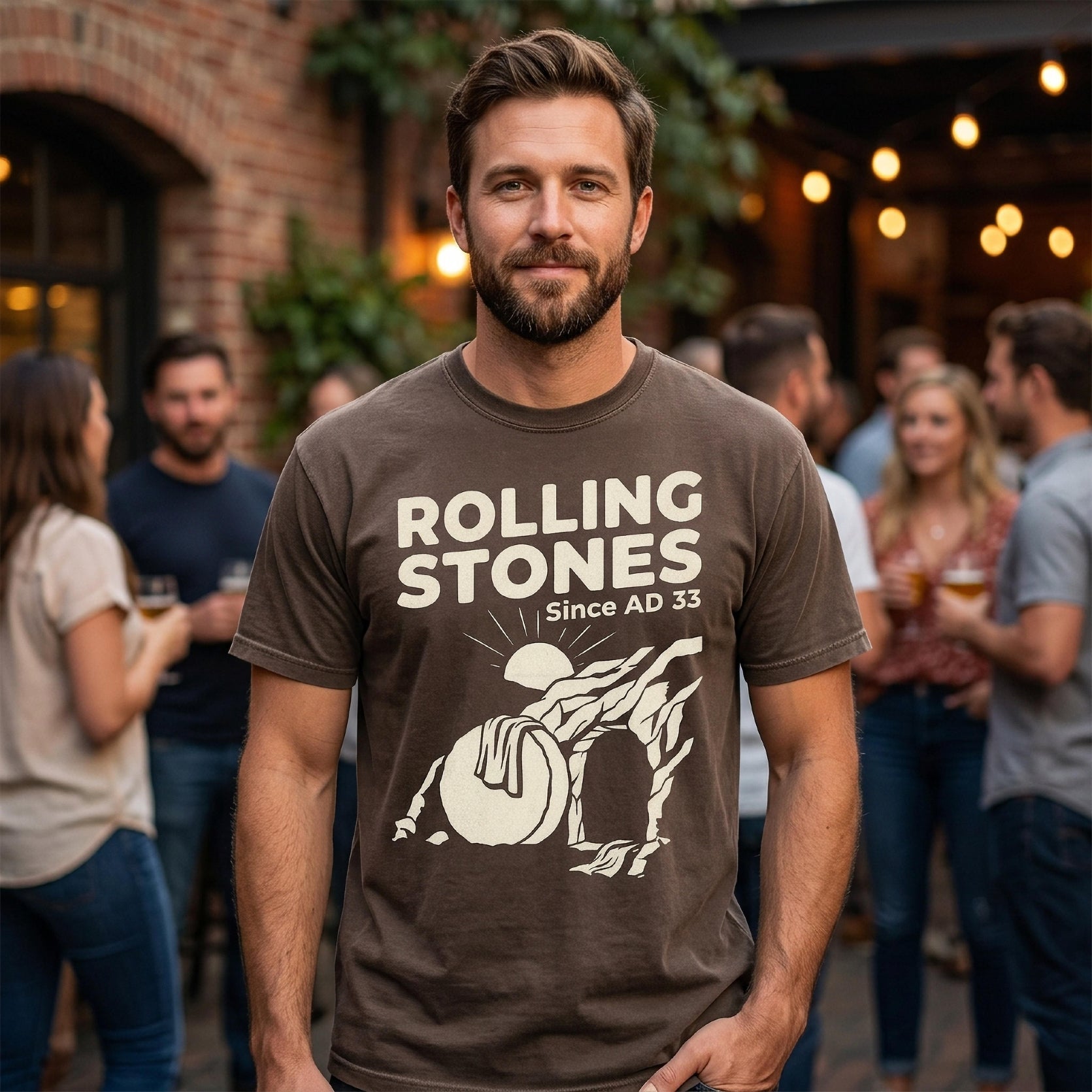 Man wearing a brown Rolling Stones "Since AD 33" t-shirt with graphic.