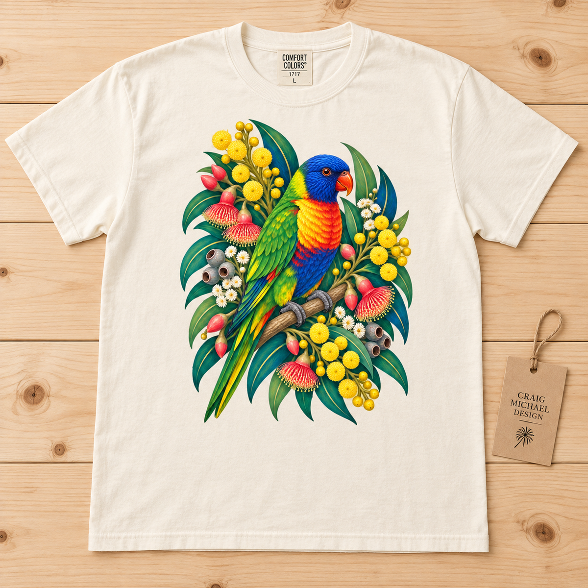 Cream t-shirt featuring a colorful rainbow lorikeet perched on a branch with Australian wildflowers.