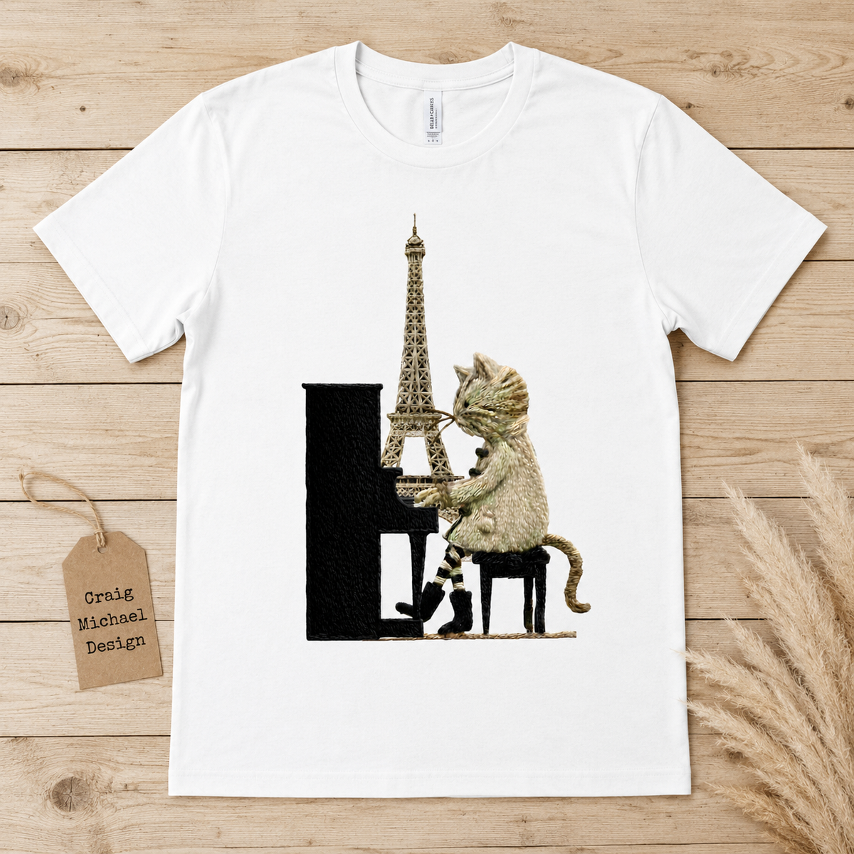 Cat playing piano with Eiffel Tower on a white t-shirt.