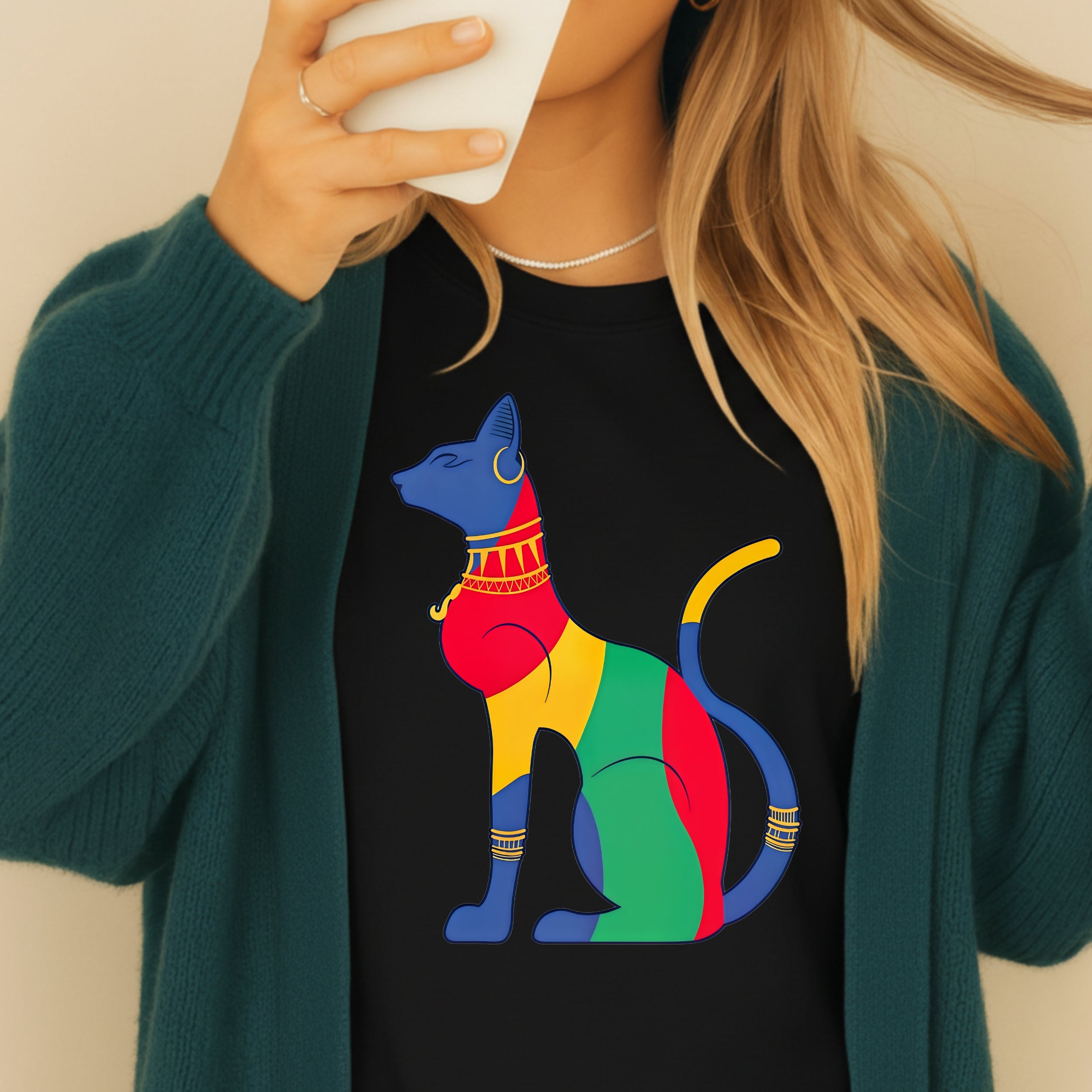 Black t-shirt featuring a colorful, stylized Egyptian cat with gold jewelry.