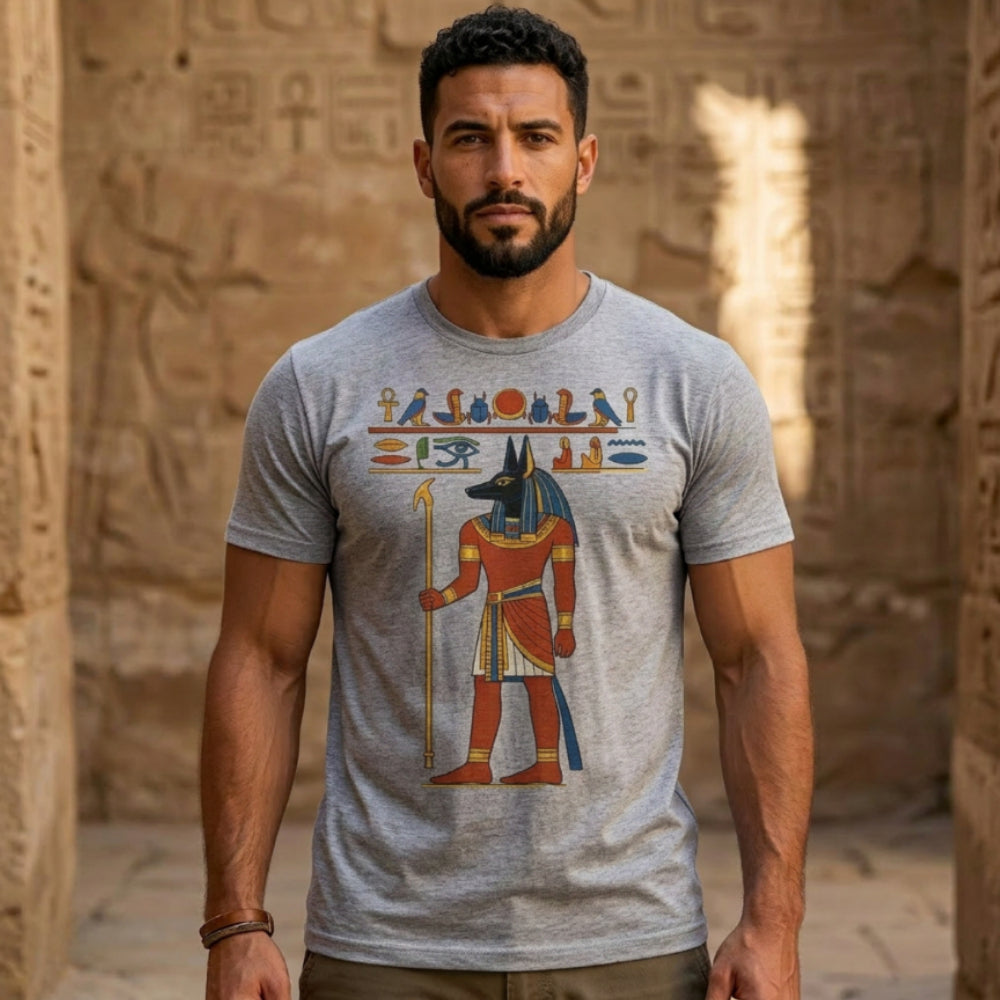 Man wearing grey t-shirt with Egyptian Anubis and hieroglyphics graphic.