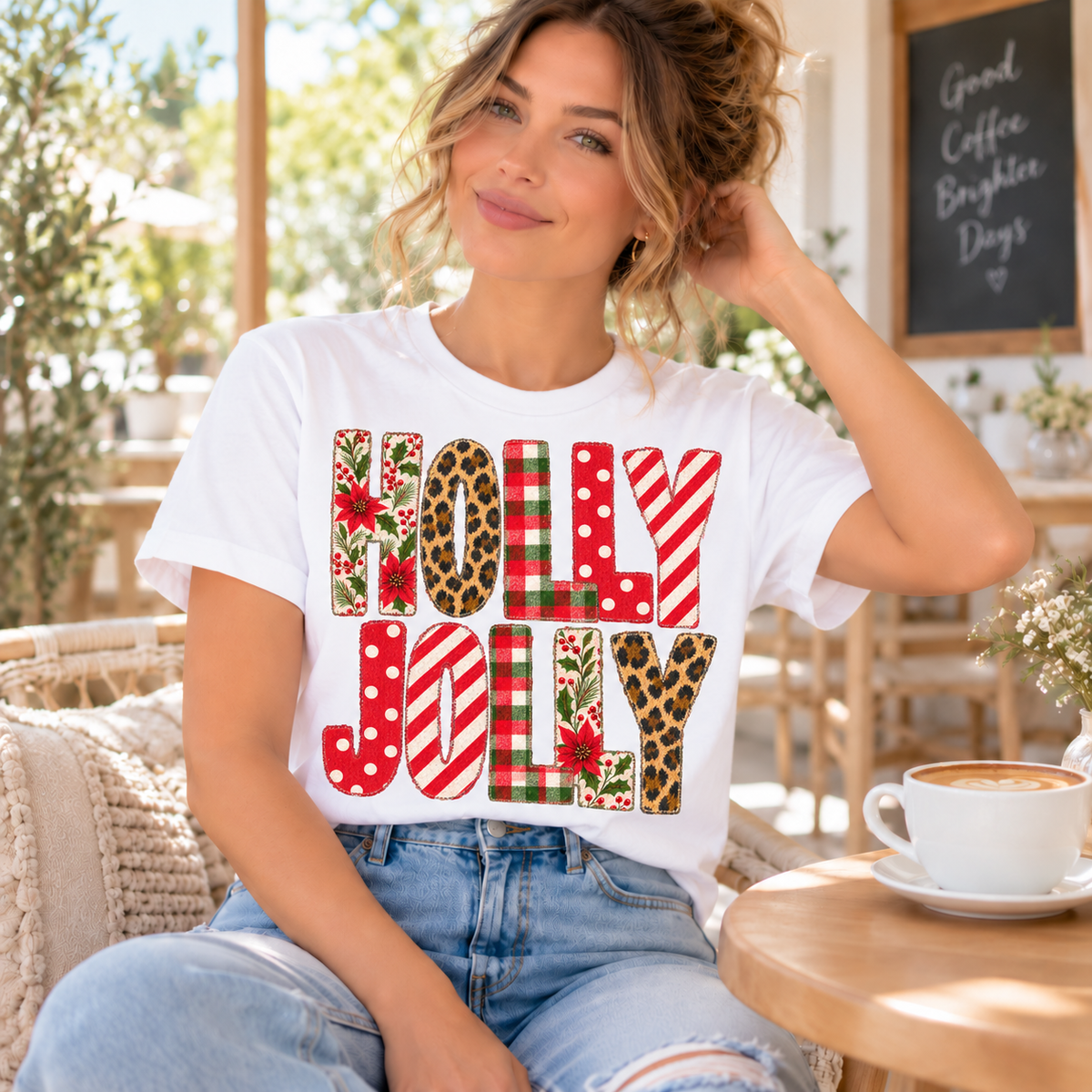 Woman wearing white t-shirt with "Holly Jolly" text in festive patterns.