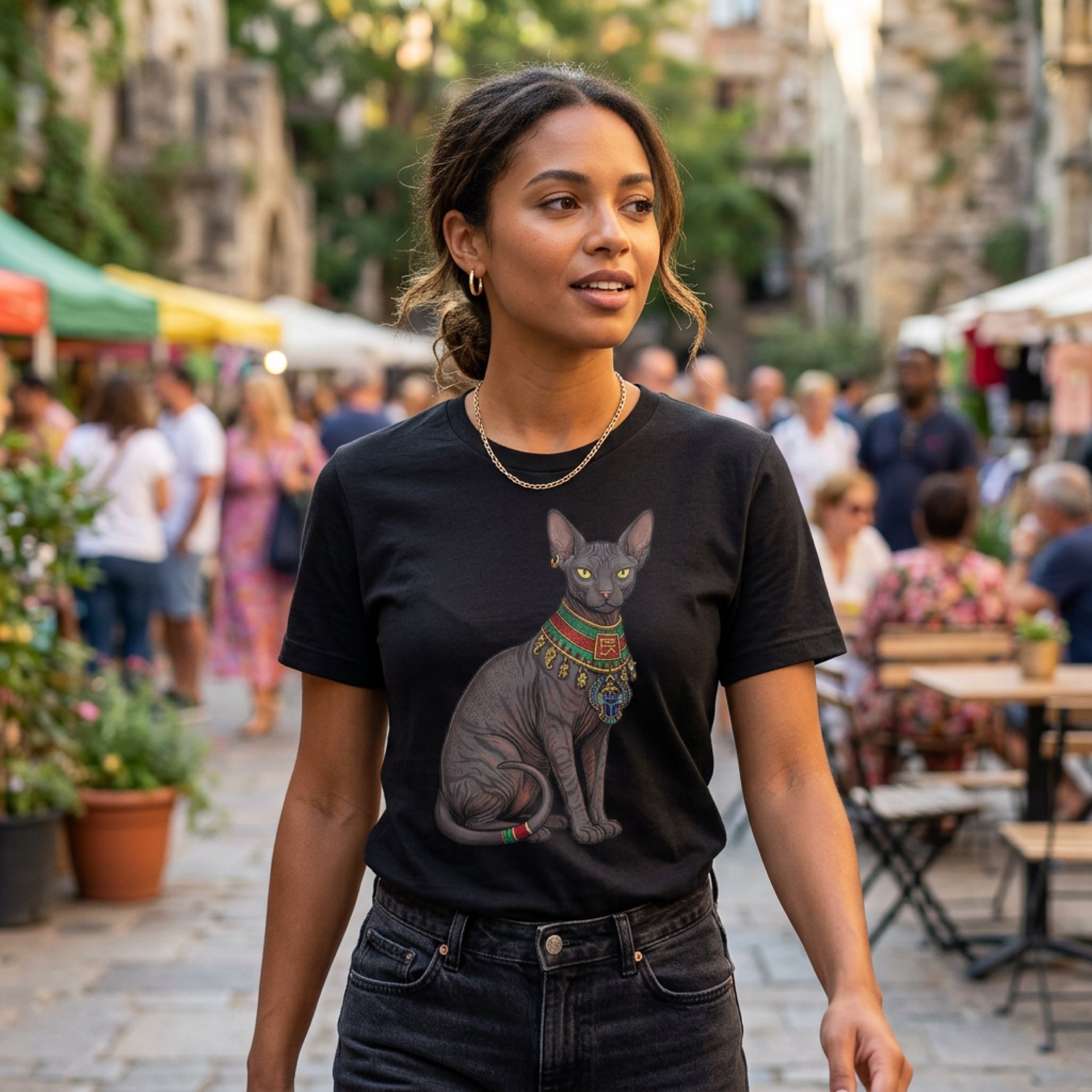 Black t-shirt with a graphic of a stylized Egyptian cat wearing ornate jewelry.