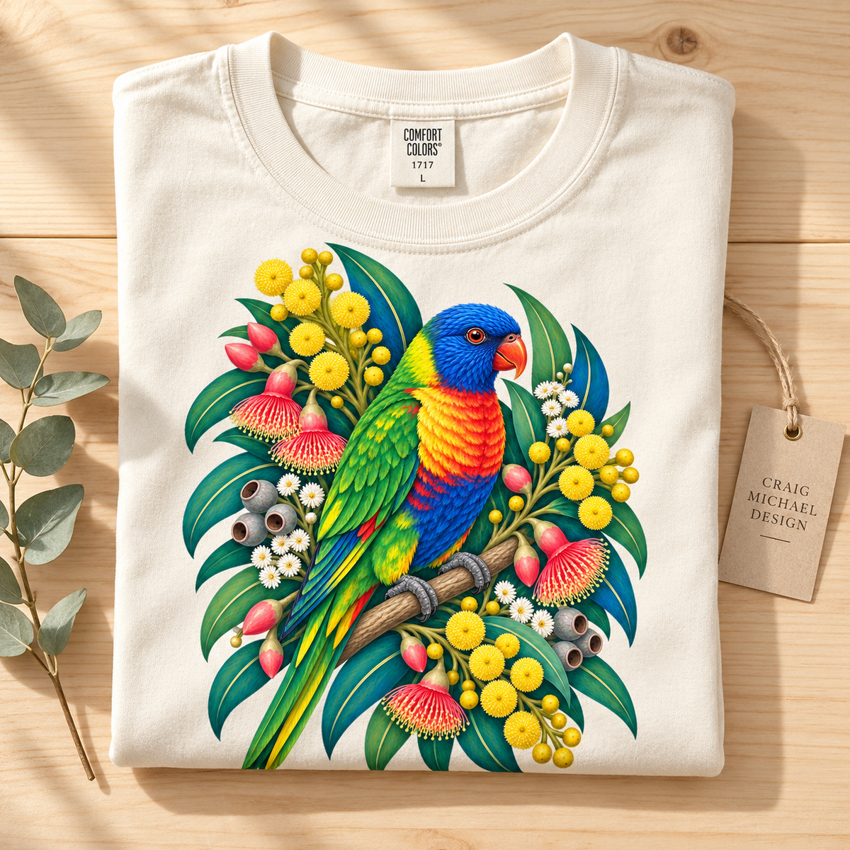 Cream t-shirt with rainbow lorikeet and Australian flora graphic, "Comfort Colors" tag.