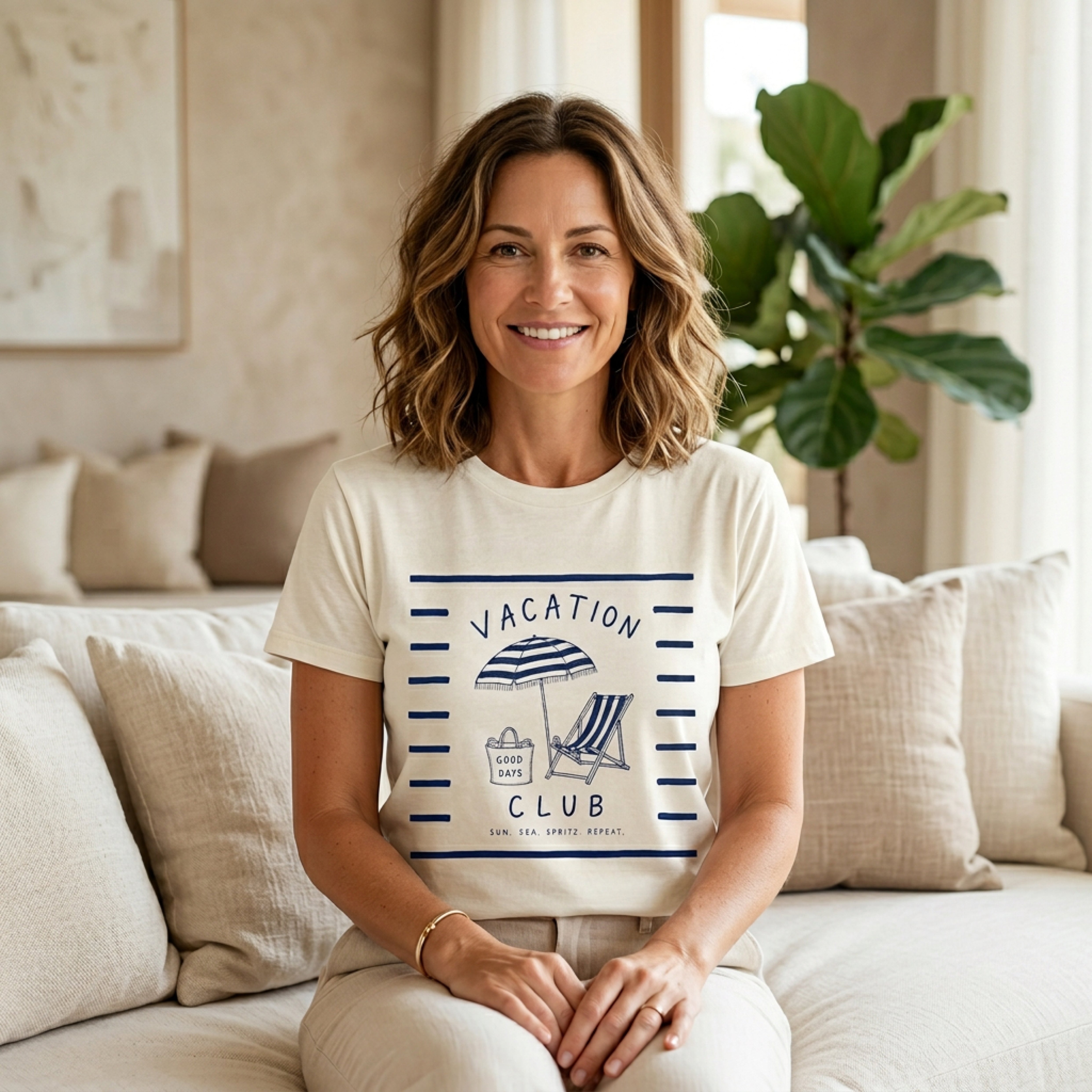 Woman wearing a "Vacation Club" t-shirt with beach umbrella and chair graphic.