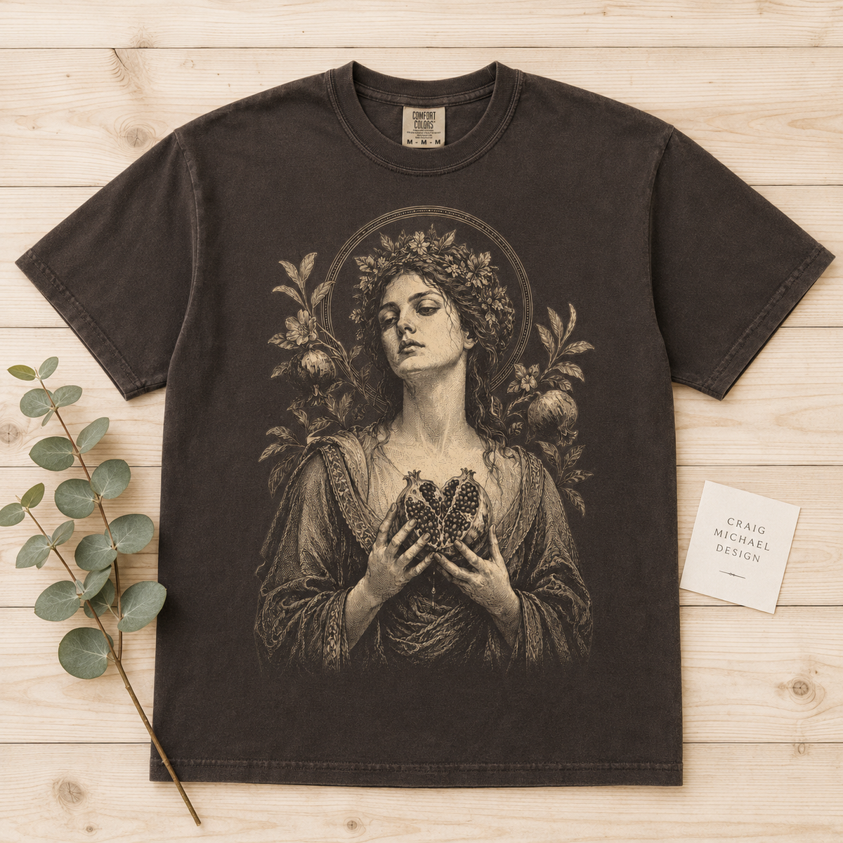 T-shirt with classical illustration of a woman holding a pomegranate heart.