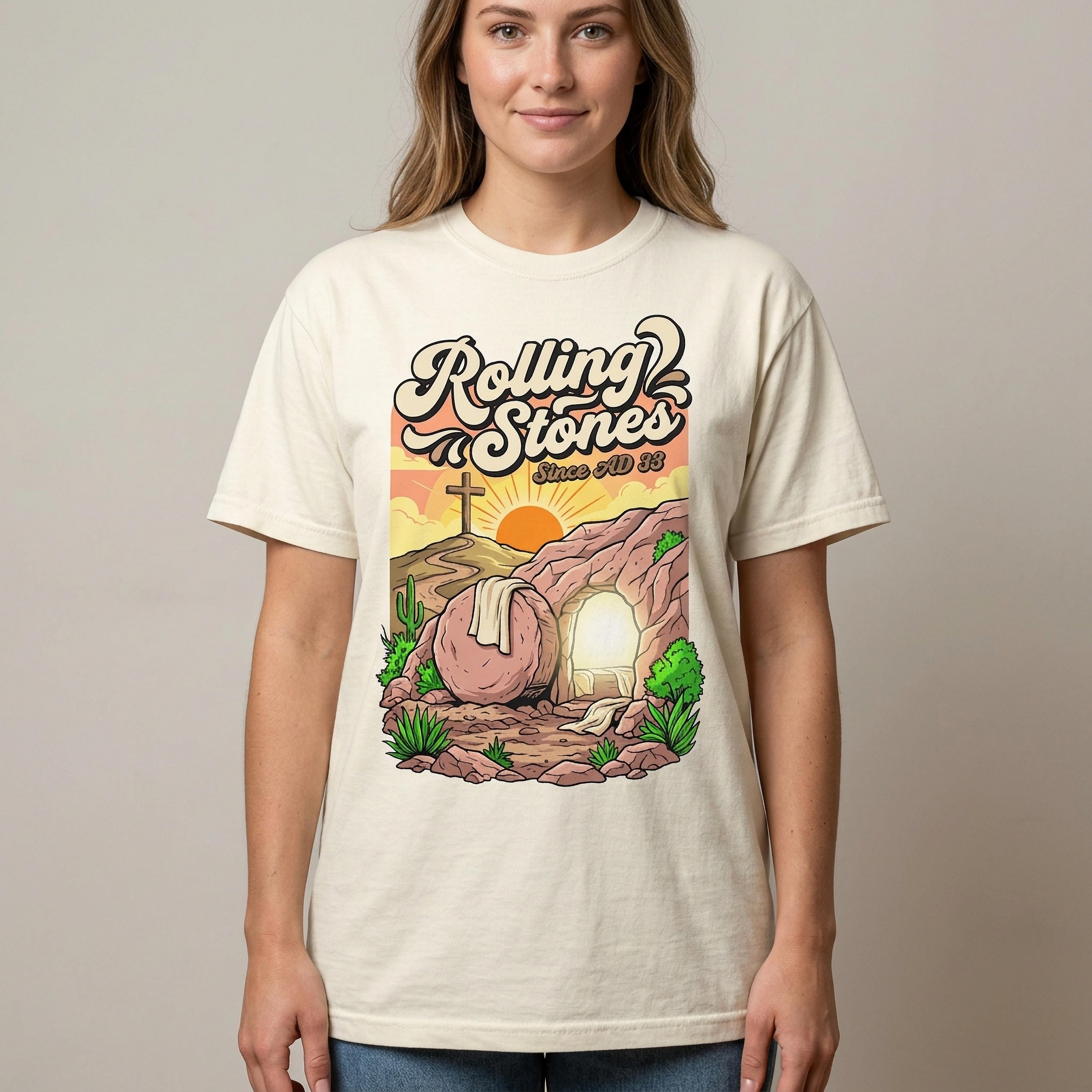 T-shirt graphic with a tomb, cross, and sun. Text: Rolling Stones Since AD 33.