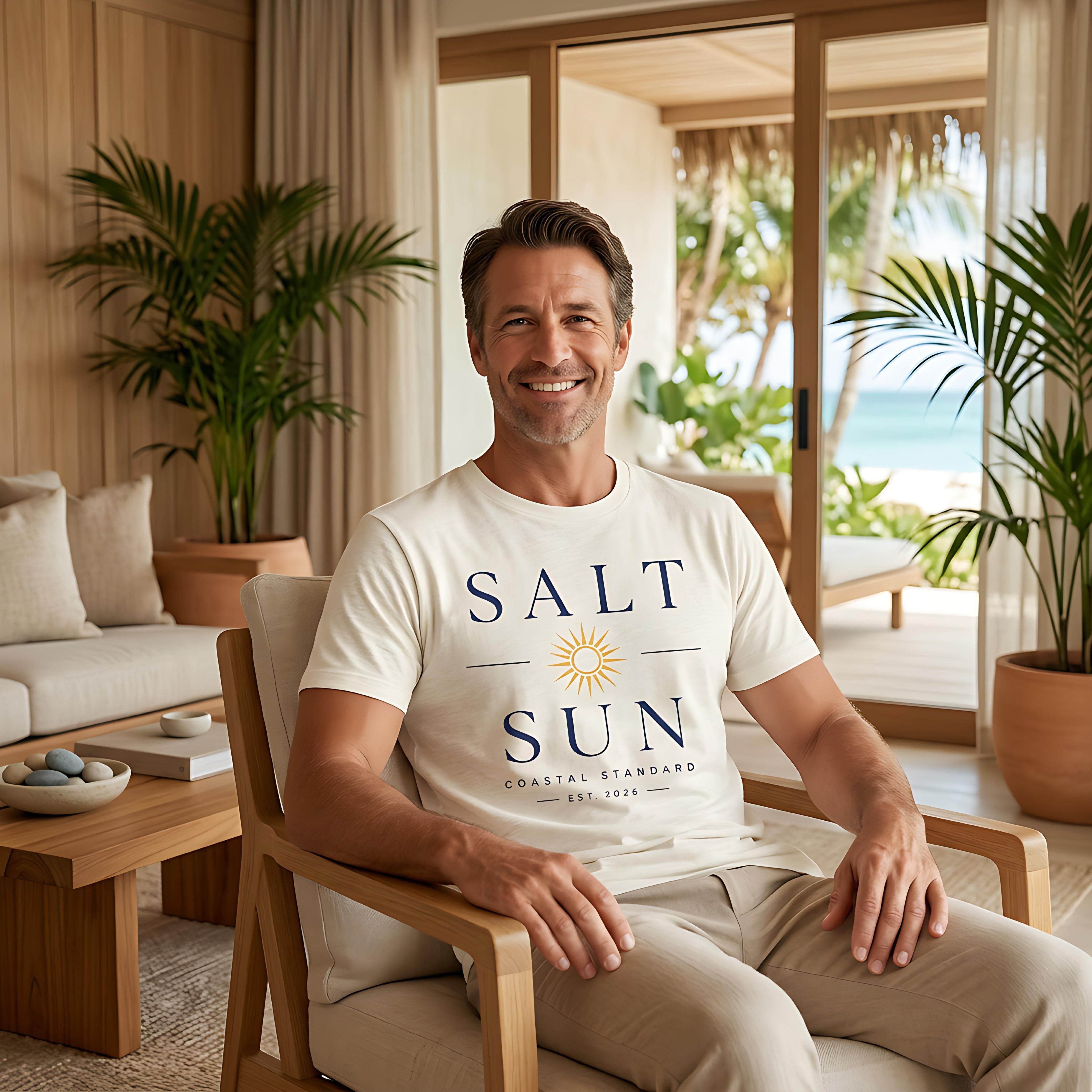 Man wearing Salt Standard t-shirt sitting in armchair with coastal view.