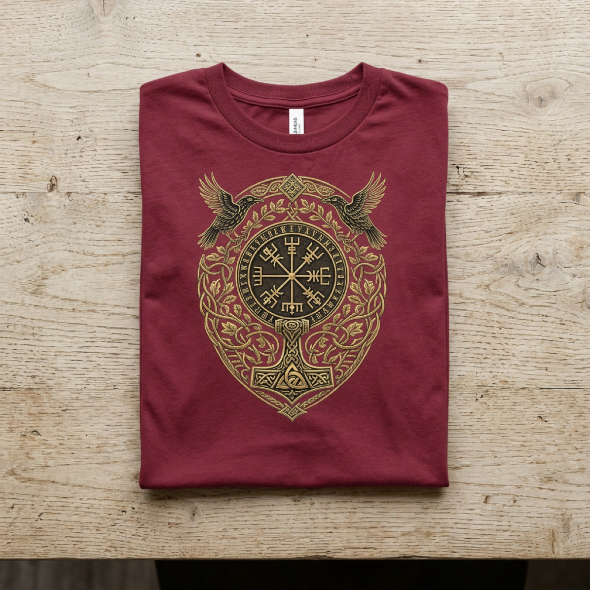 Maroon t-shirt with gold Norse Vegvisir and Mjolnir design.