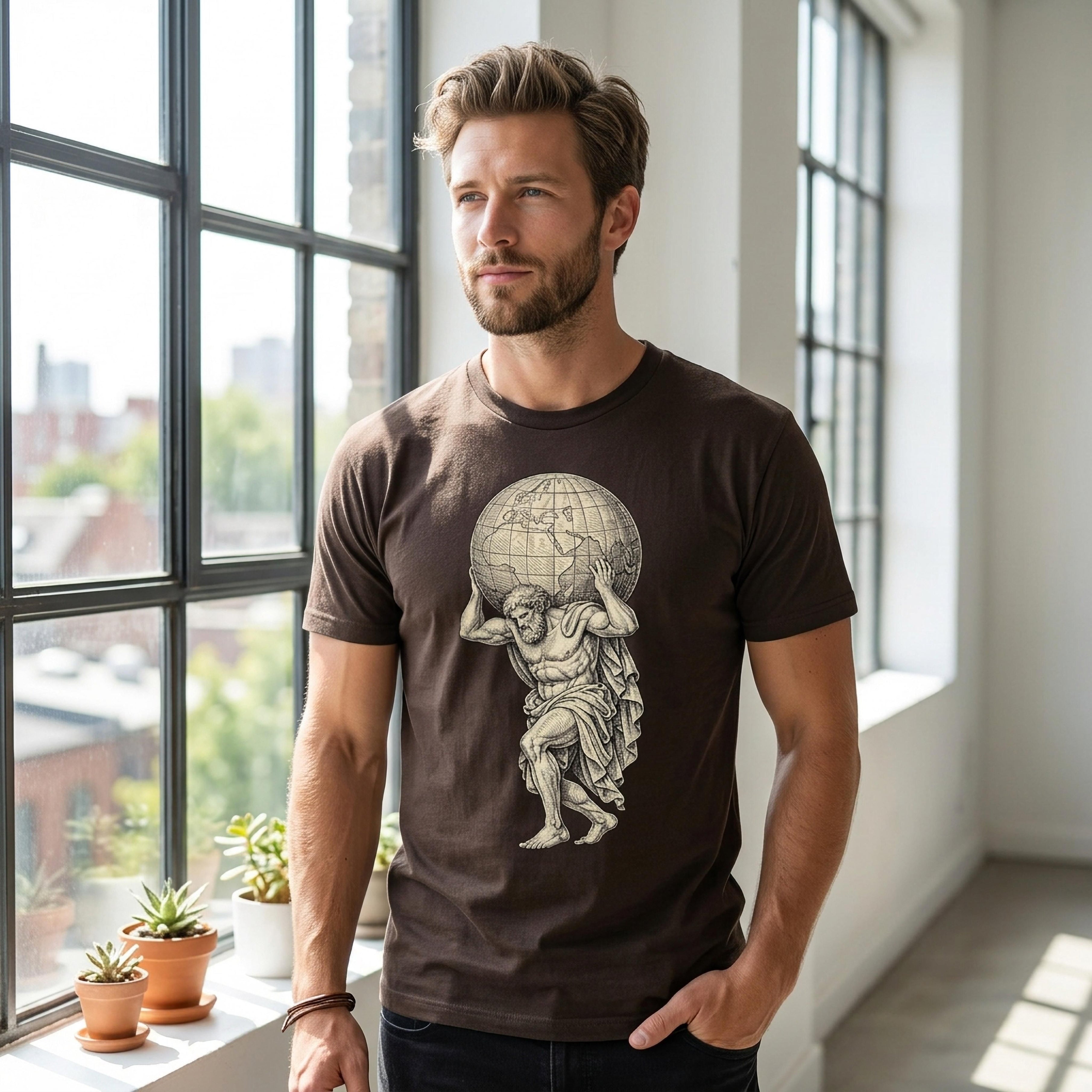 Man wearing brown t-shirt with Atlas holding globe graphic.