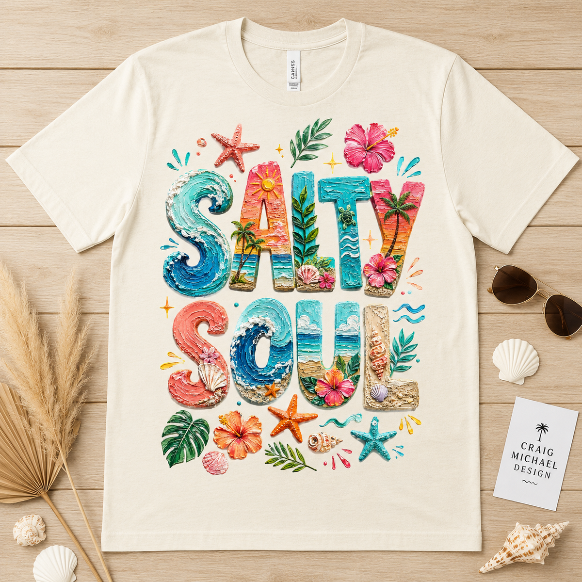 Cream t-shirt with "SALTY SOUL" text design featuring beach and tropical elements.