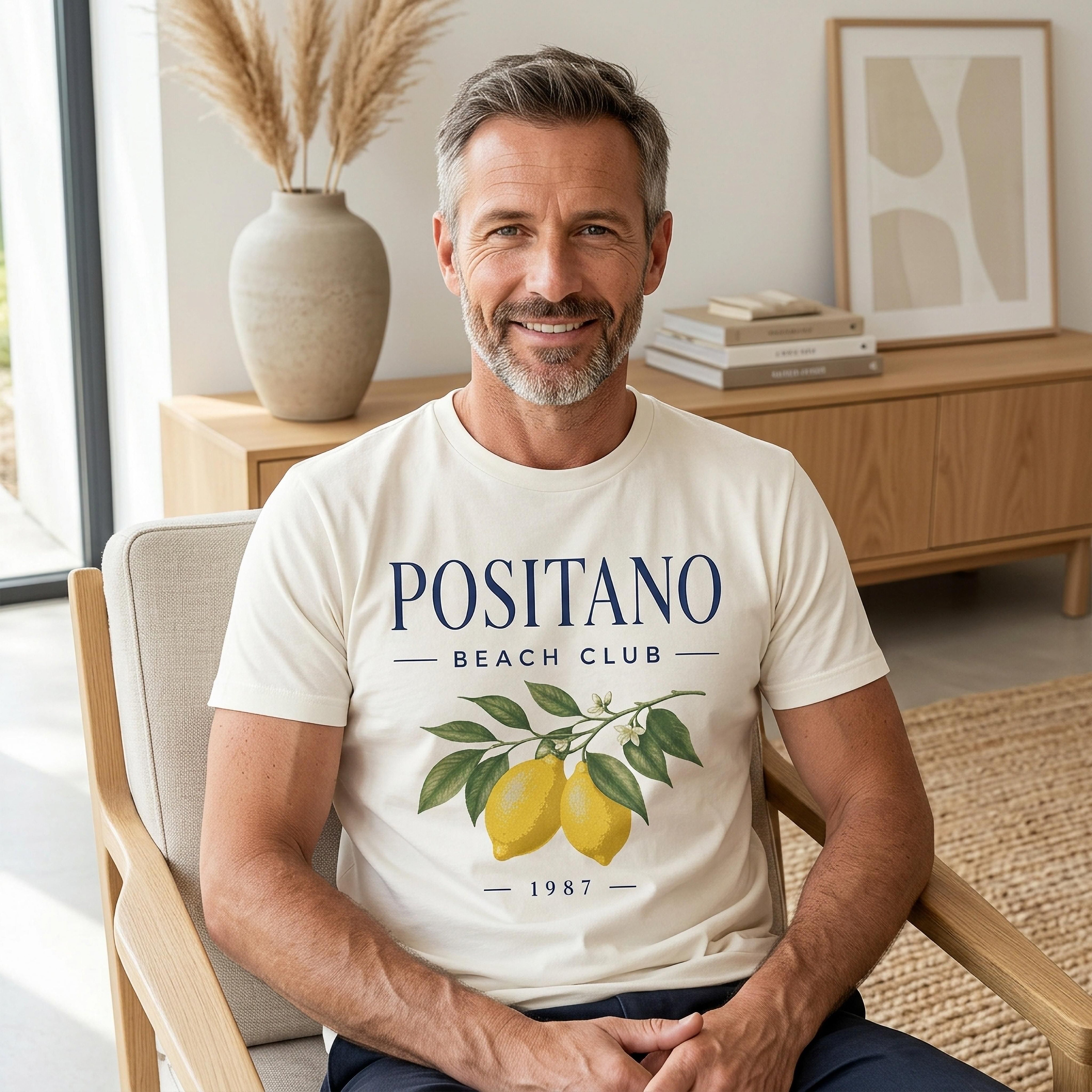 Man in cream t-shirt with "POSITANO BEACH CLUB 1987" and lemon illustration.