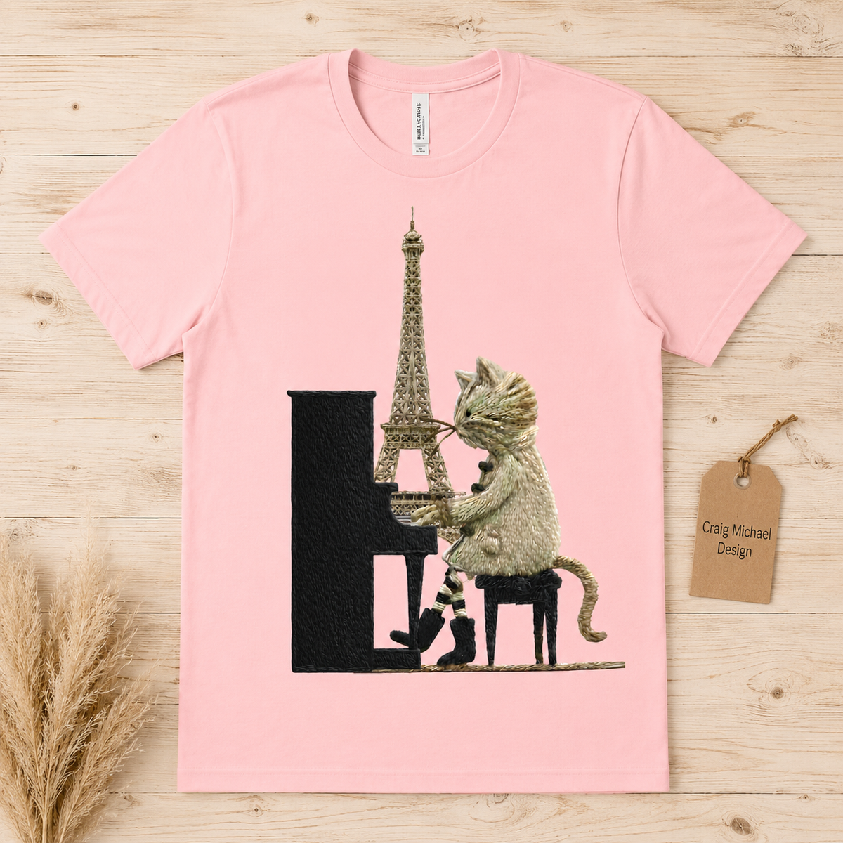 Cat playing piano with Eiffel Tower and Paris backdrop on pink t-shirt.