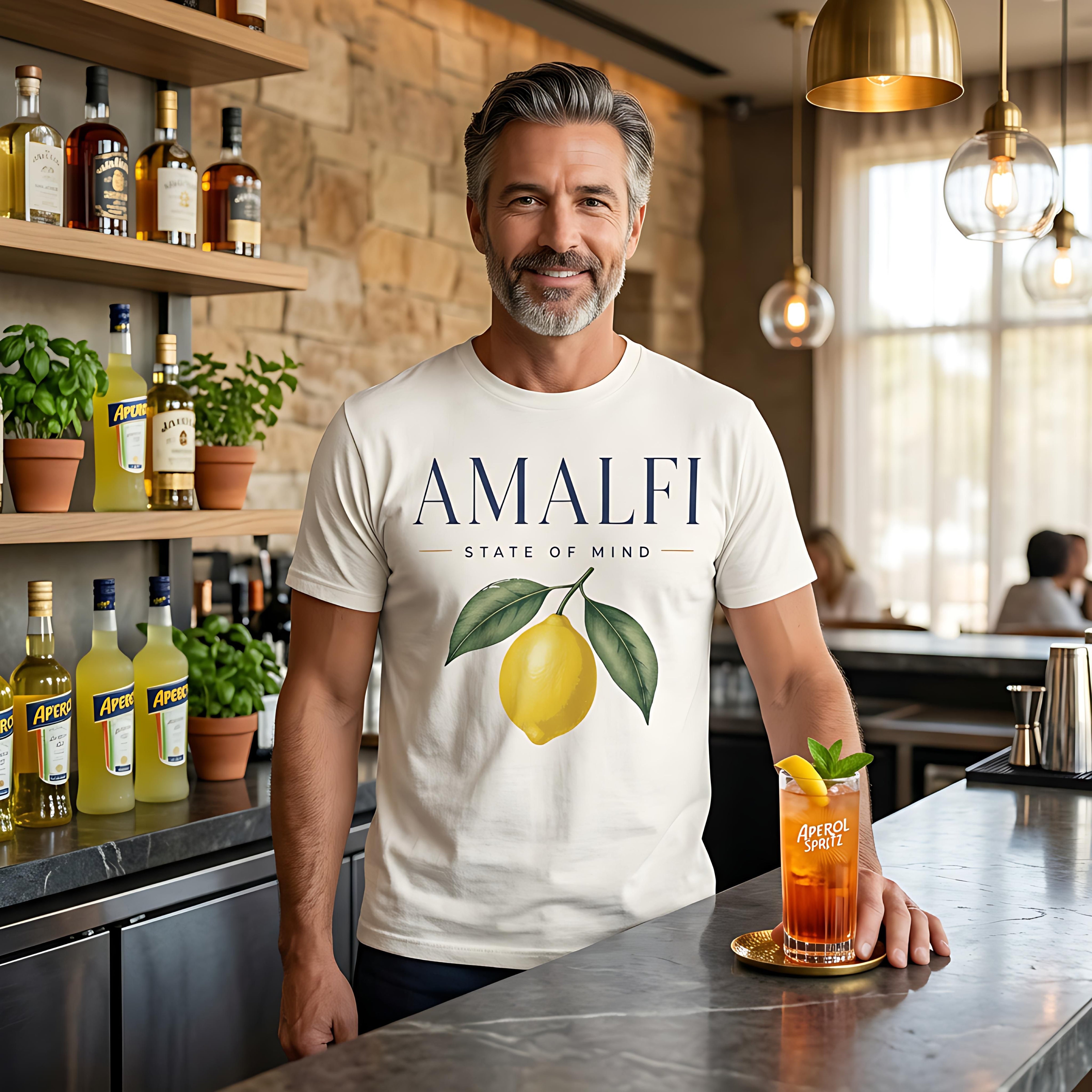 Man in "AMALFI STATE OF MIND" t-shirt holding an Aperol Spritz.