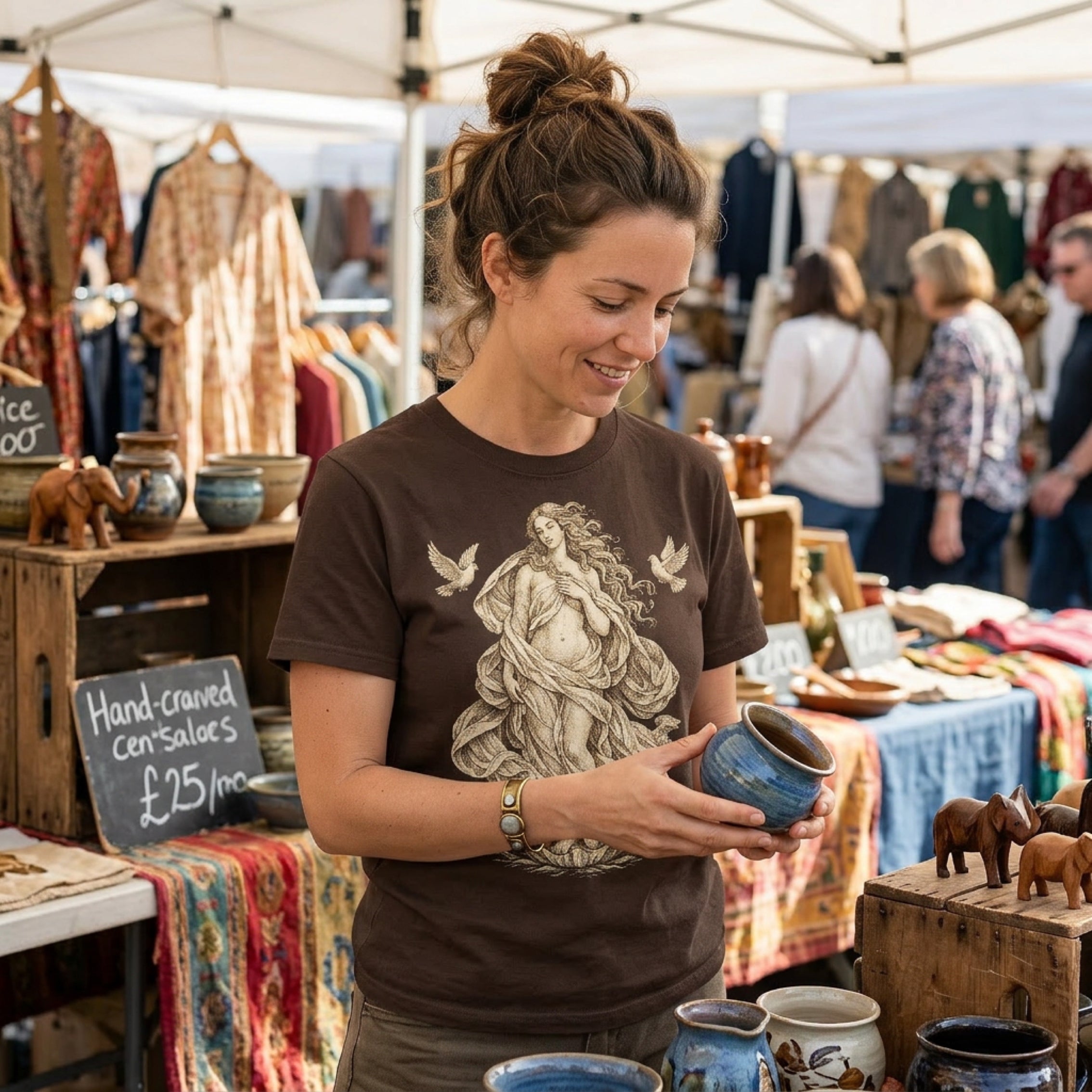 Woman holding a small blue ceramic pot at an outdoor market stall.