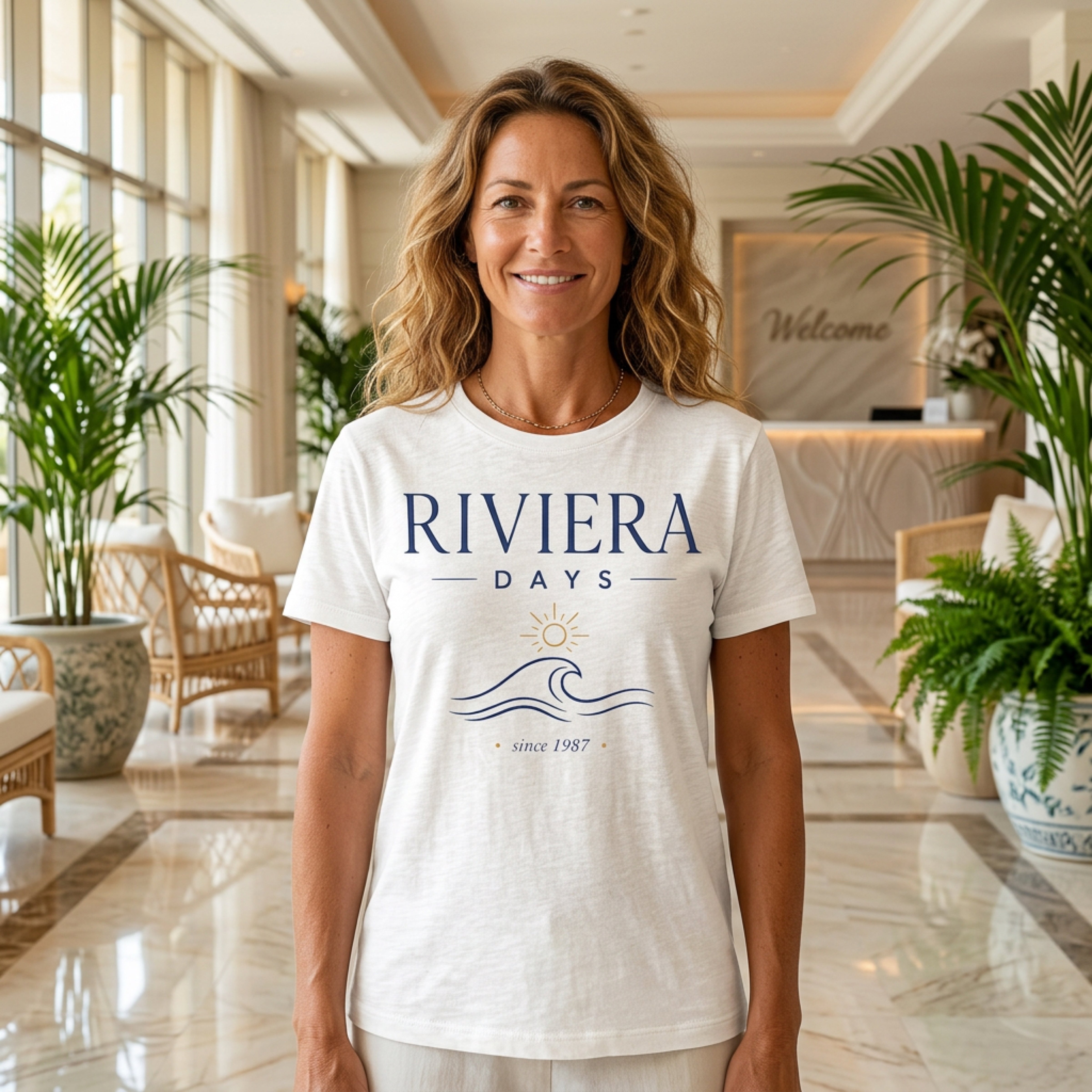 Woman wearing a white "Riviera Days Since 1987" t-shirt.