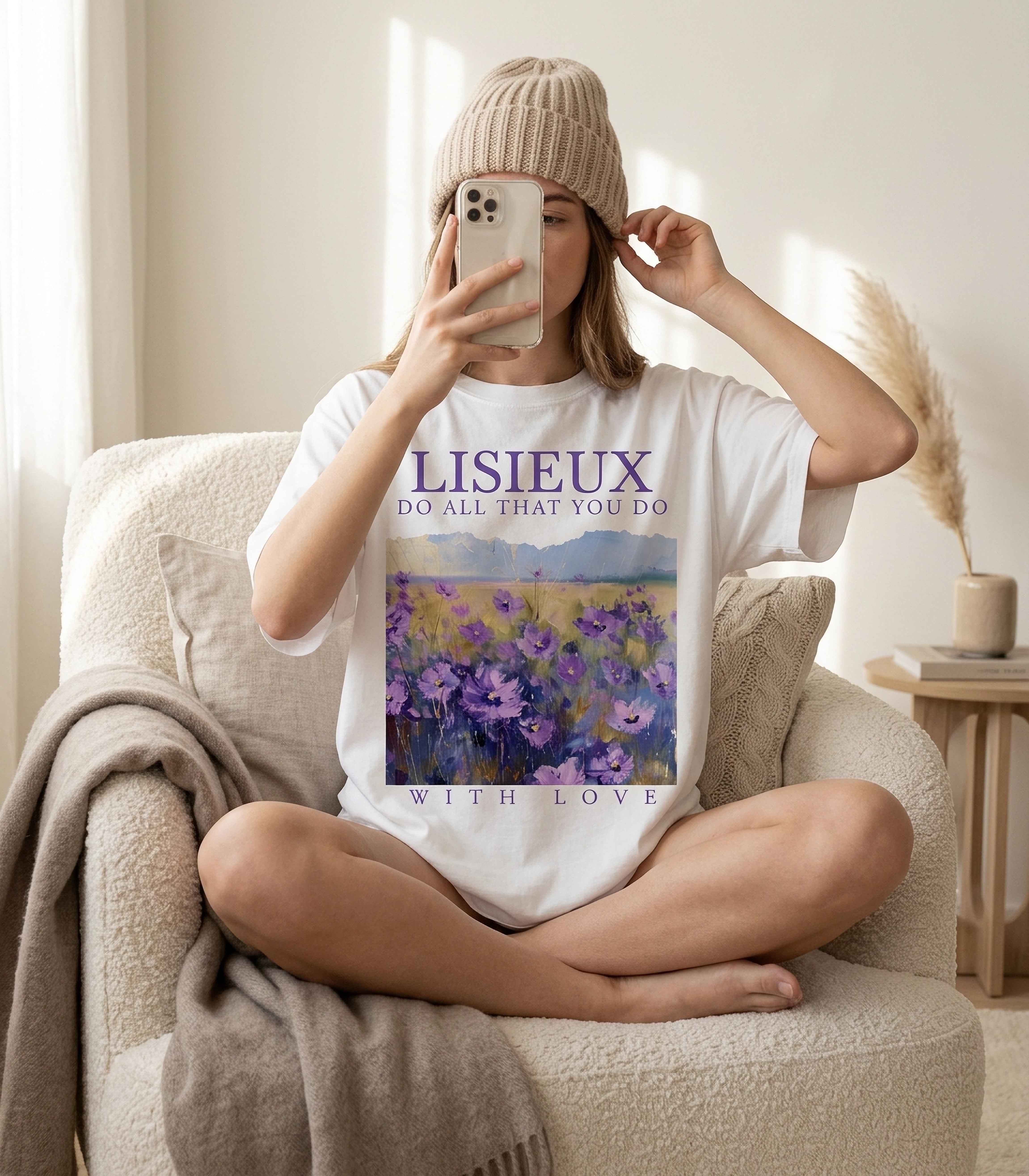 Woman wearing white t-shirt with "LISIEUX DO ALL THAT YOU LOVE WITH LOVE" and floral art.