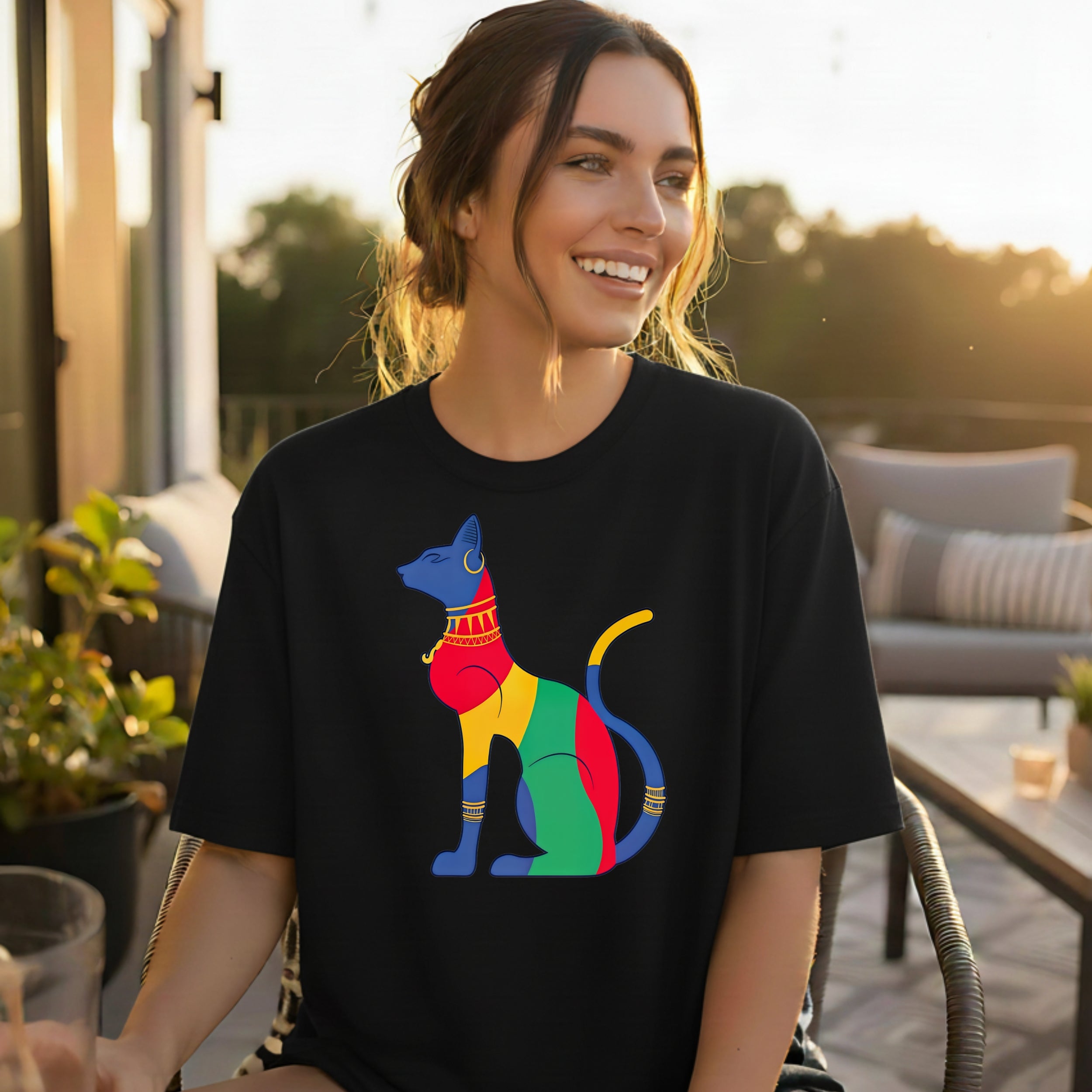 Black t-shirt with colorful Egyptian cat graphic.