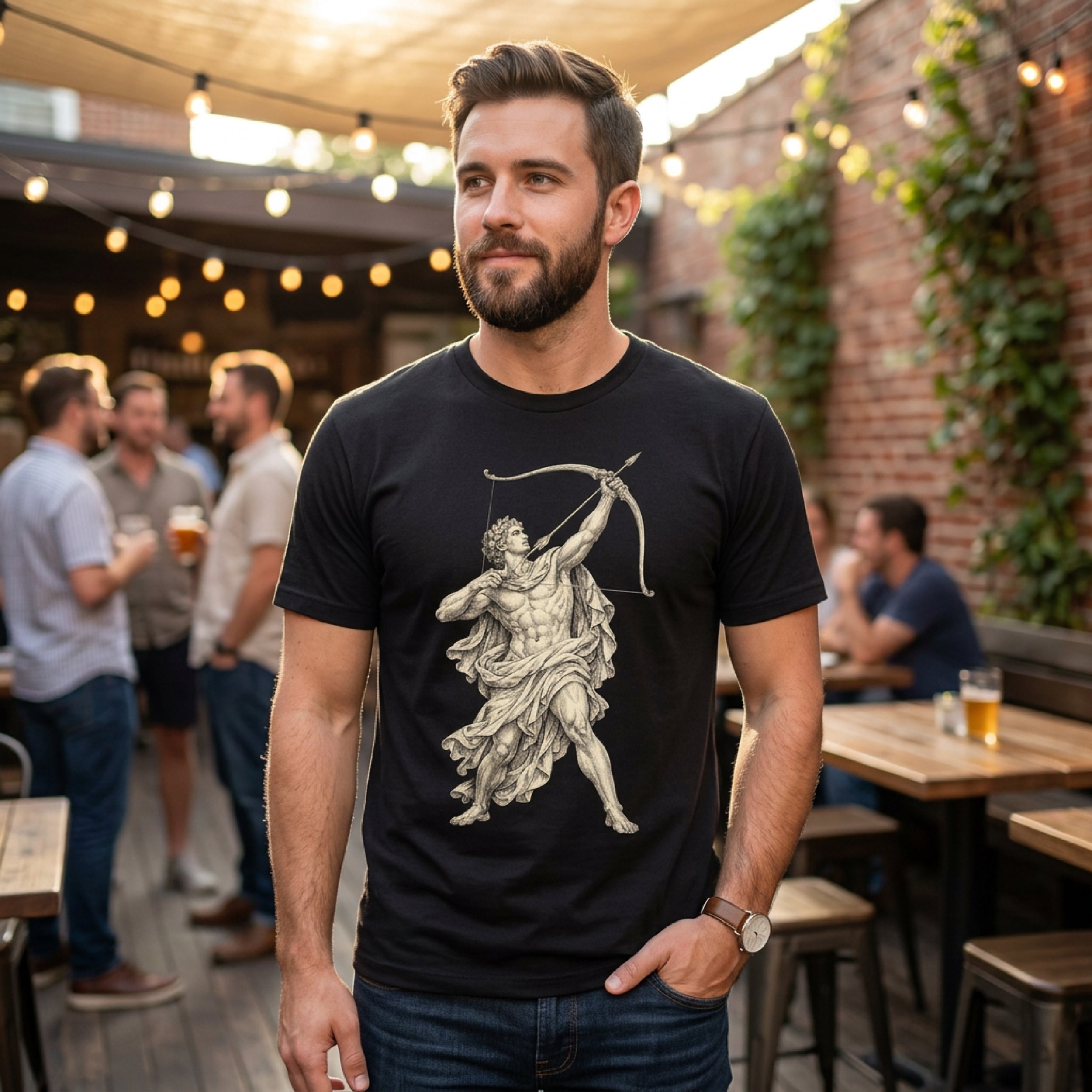 Man wearing black t-shirt with depiction of archer, standing outdoors.