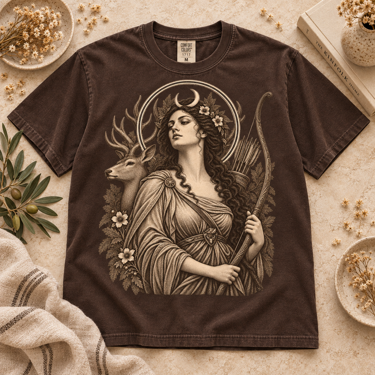 Brown t-shirt with a graphic of a woman with a bow and a deer.