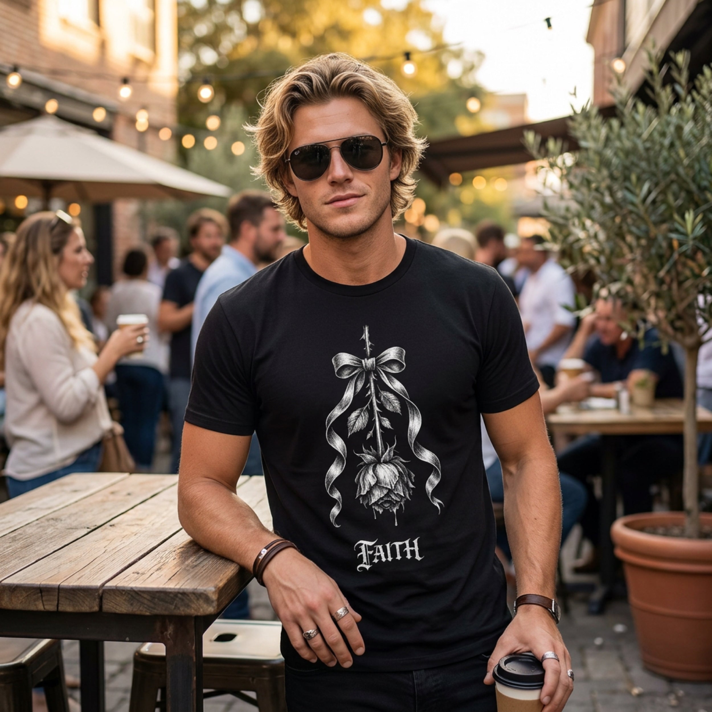 Man in black t-shirt with rose ribbon design and "Faith" text.