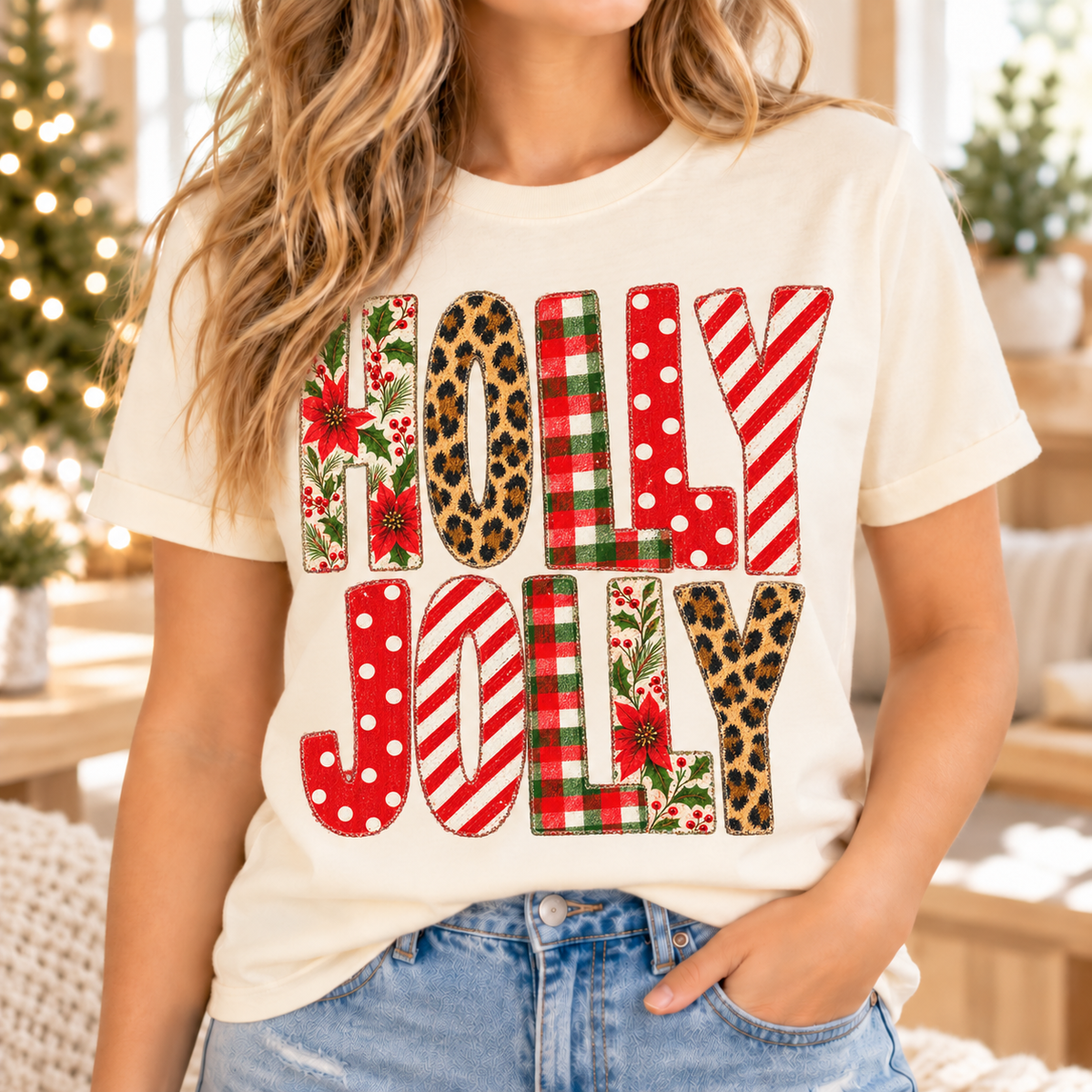 Cream t-shirt with "HOLLY JOLLY" in festive patterns: poinsettias, leopard, plaid, polka dots, and stripes.