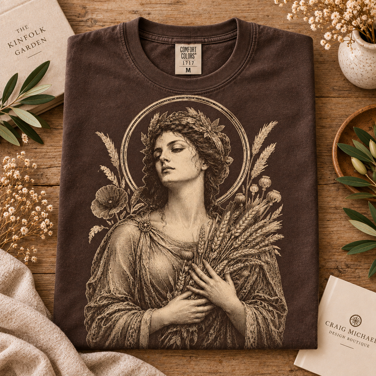Brown t-shirt with vintage depiction of woman in laurel wreath holding wheat stalks.