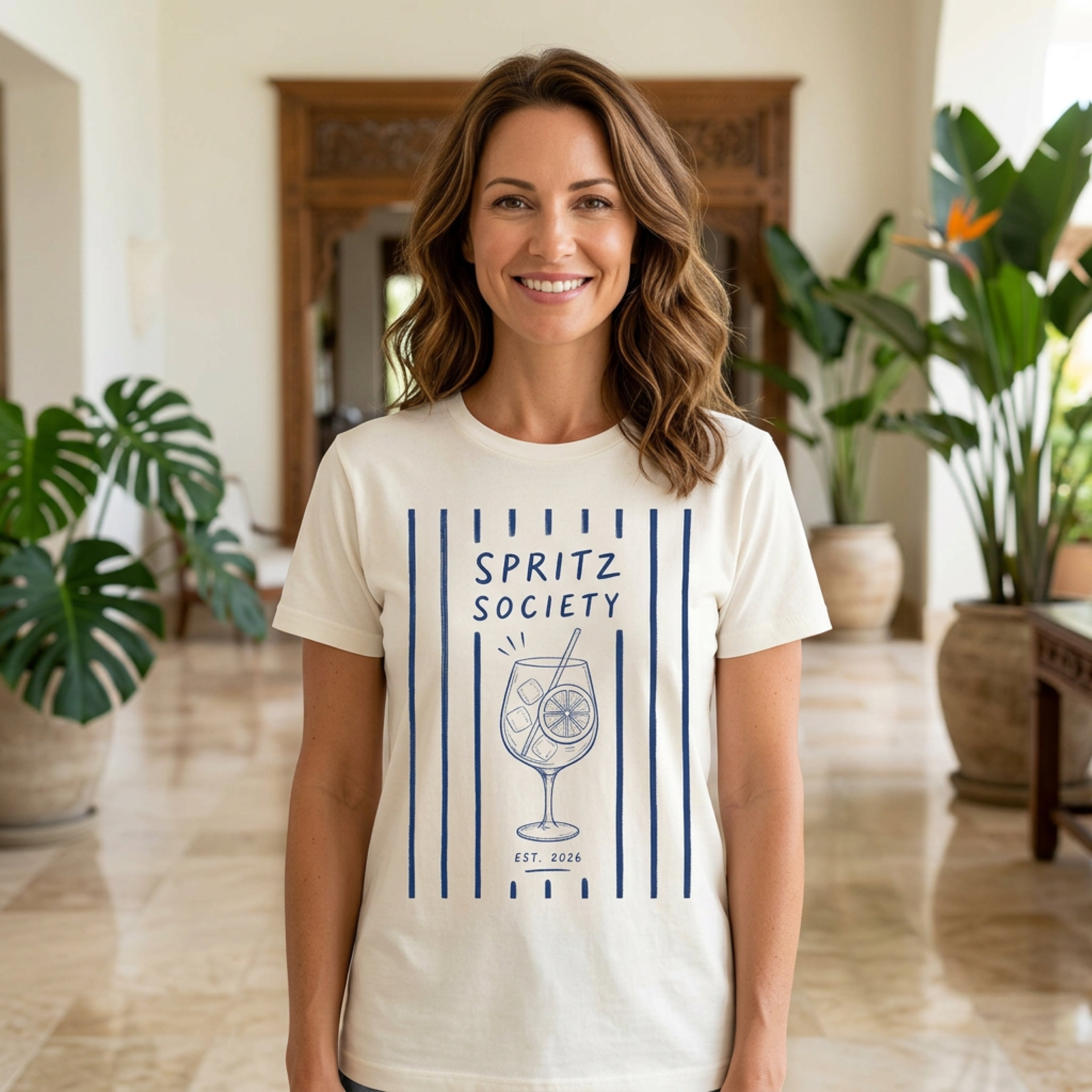 Cream t-shirt with "Spritz Society Est. 2026" and a spritz cocktail graphic.
