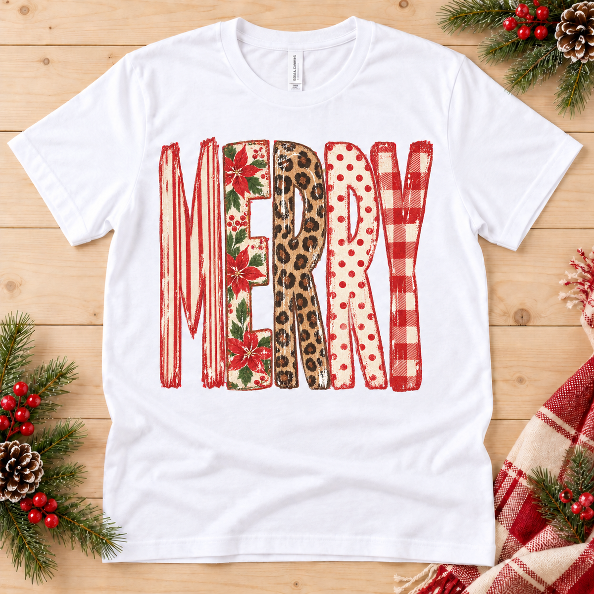 White t-shirt with "MERRY" text in various Christmas patterns.