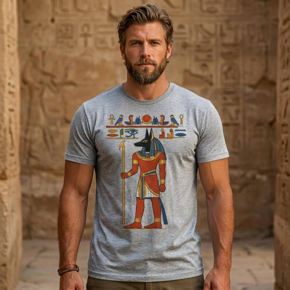 Man wearing grey t-shirt with Egyptian god Anubis graphic.