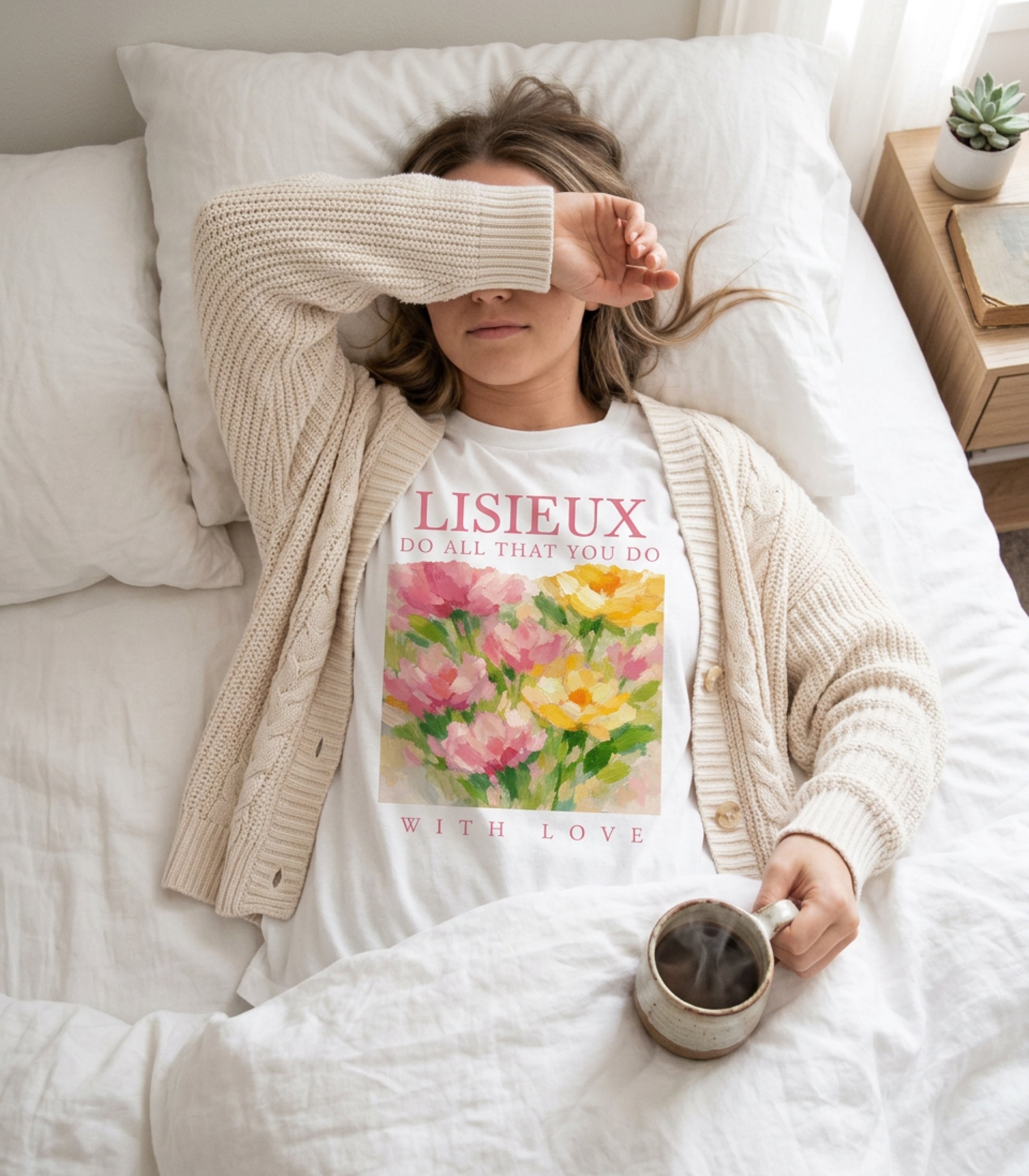Woman in bed wearing t-shirt with "Lisieaux Do All That You Do With Love" text.