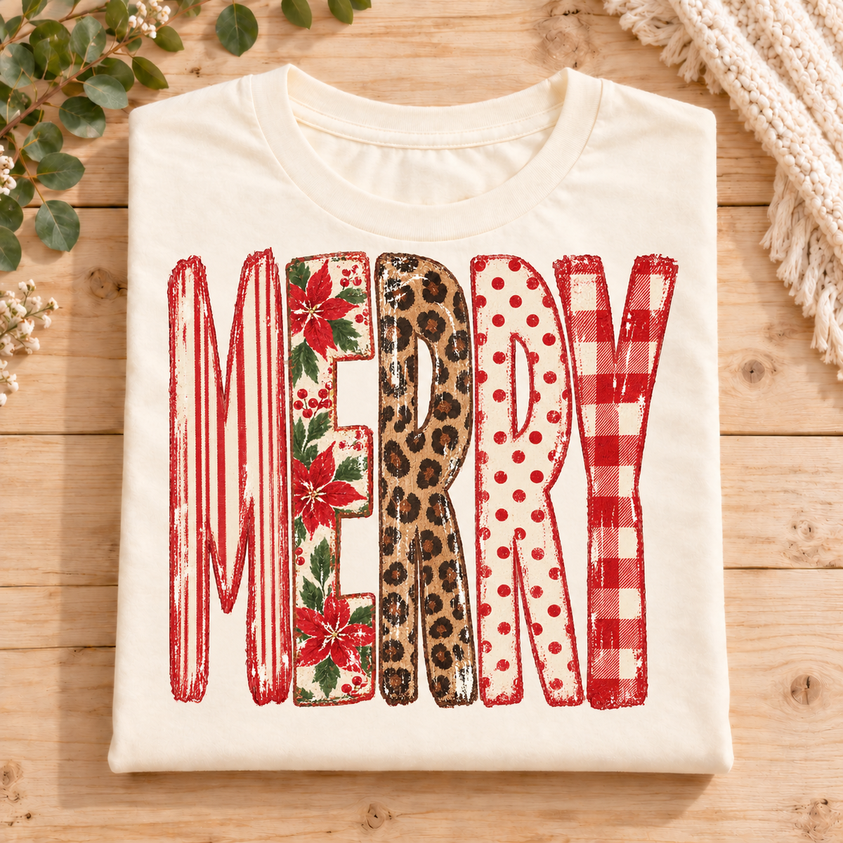 Cream t-shirt with the word MERRY in patterned block letters.