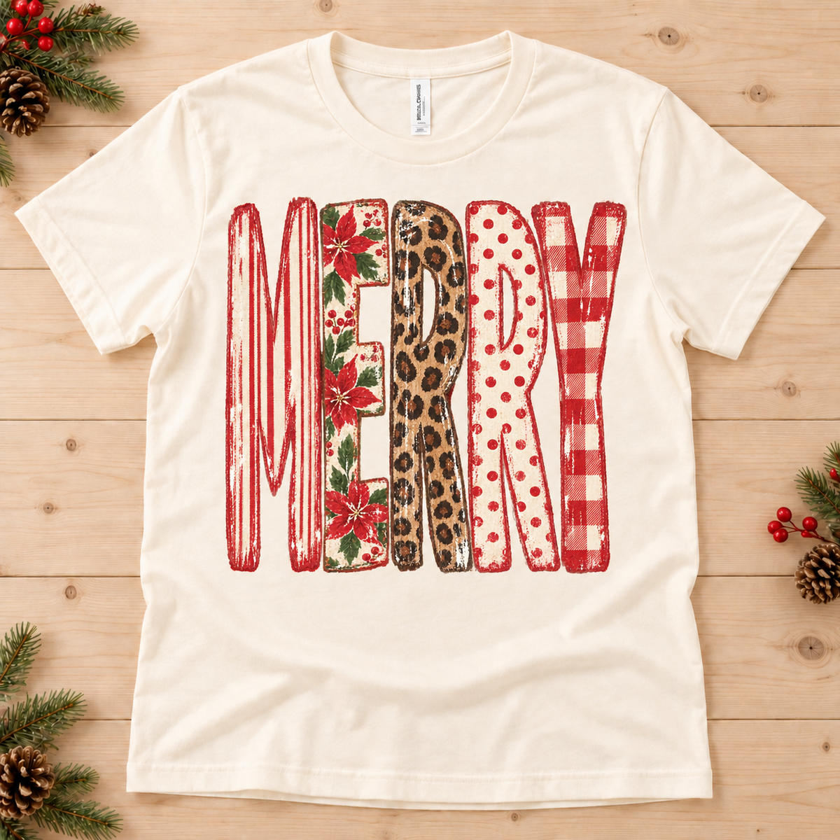 Cream t-shirt with "MERRY" in distressed, patterned letters: stripes, poinsettias, leopard, polka dots, buffalo check.