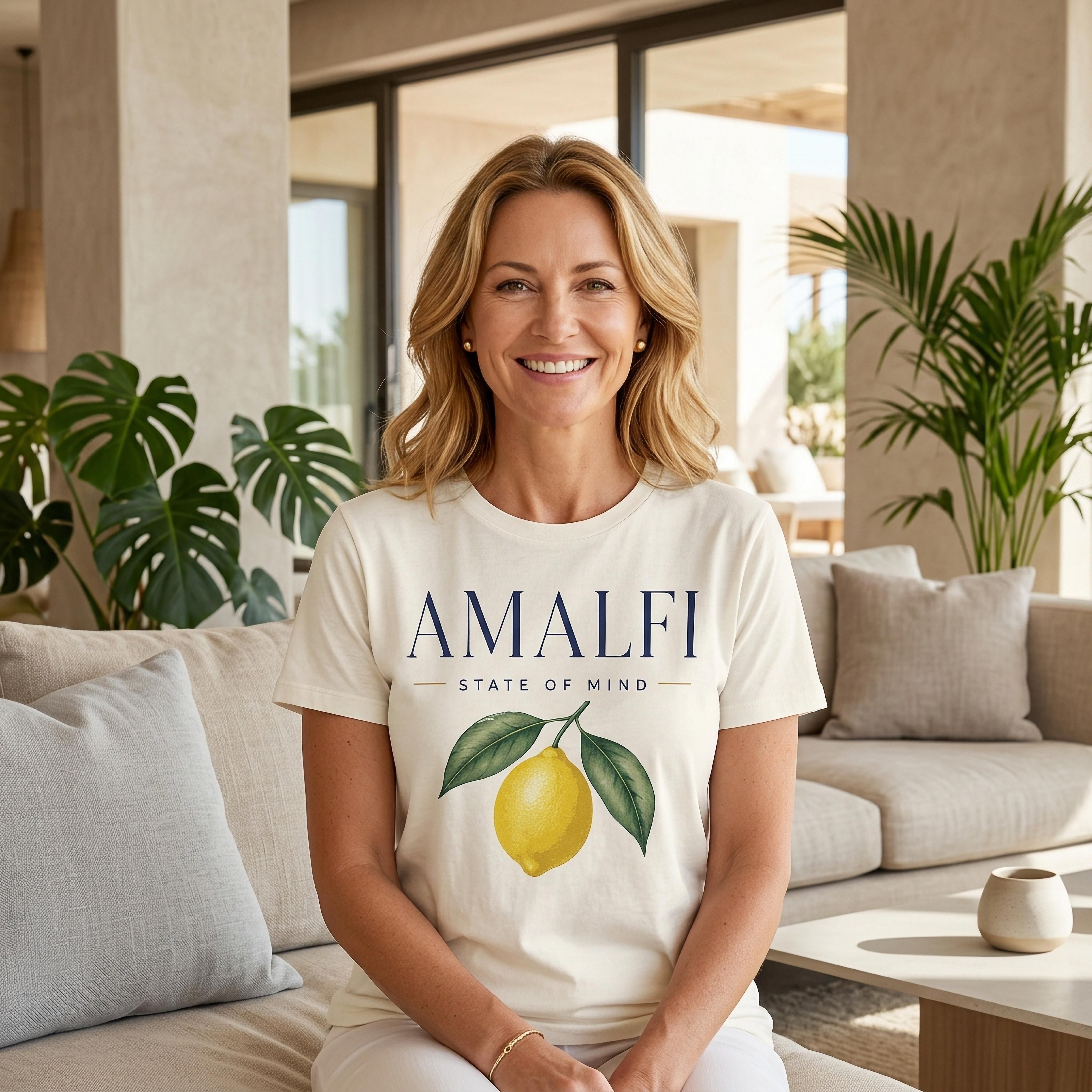 Woman wearing a t-shirt with "Amalfi State of Mind" and lemon graphic.