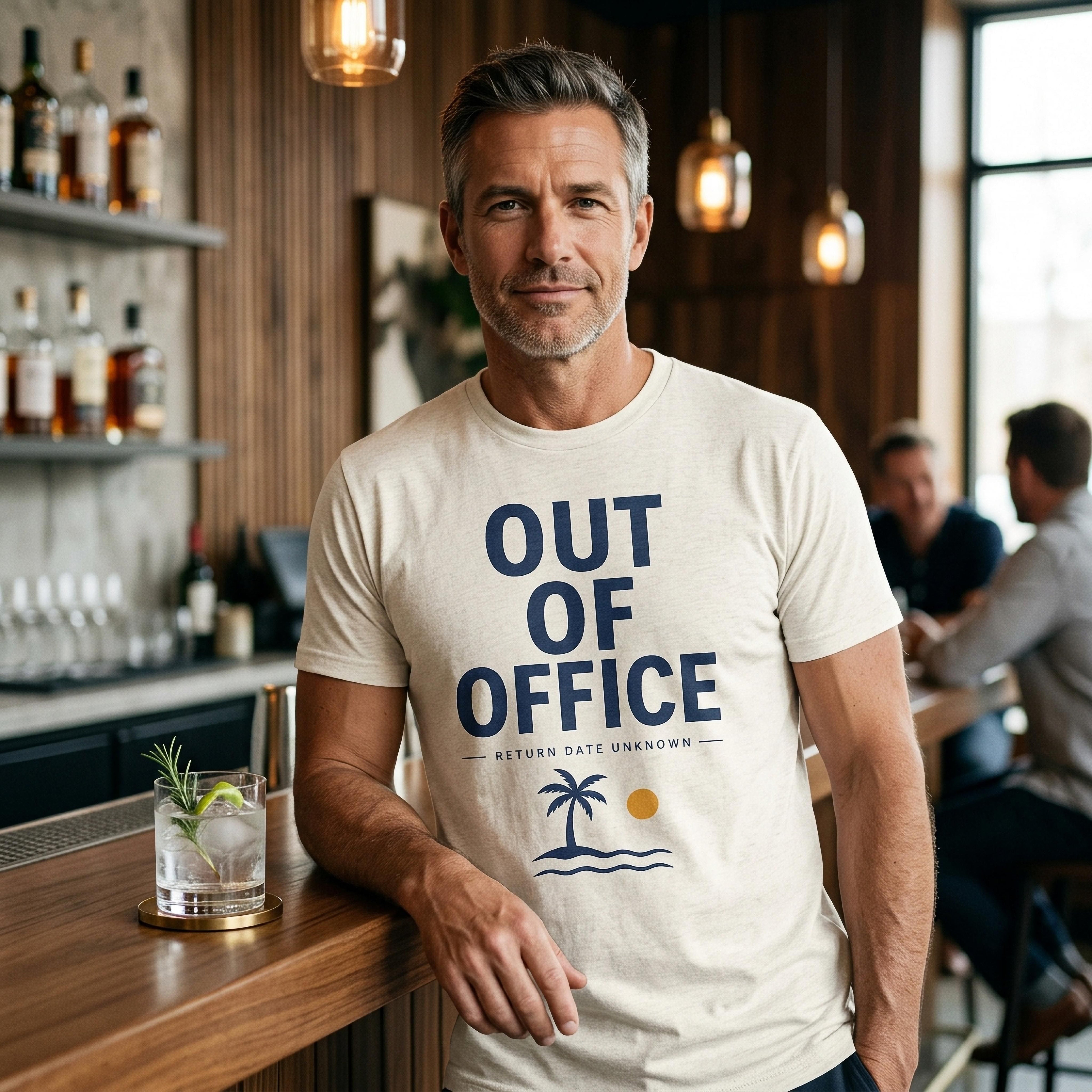 Man wearing a cream t-shirt with "OUT OF OFFICE" text and a palm tree graphic.