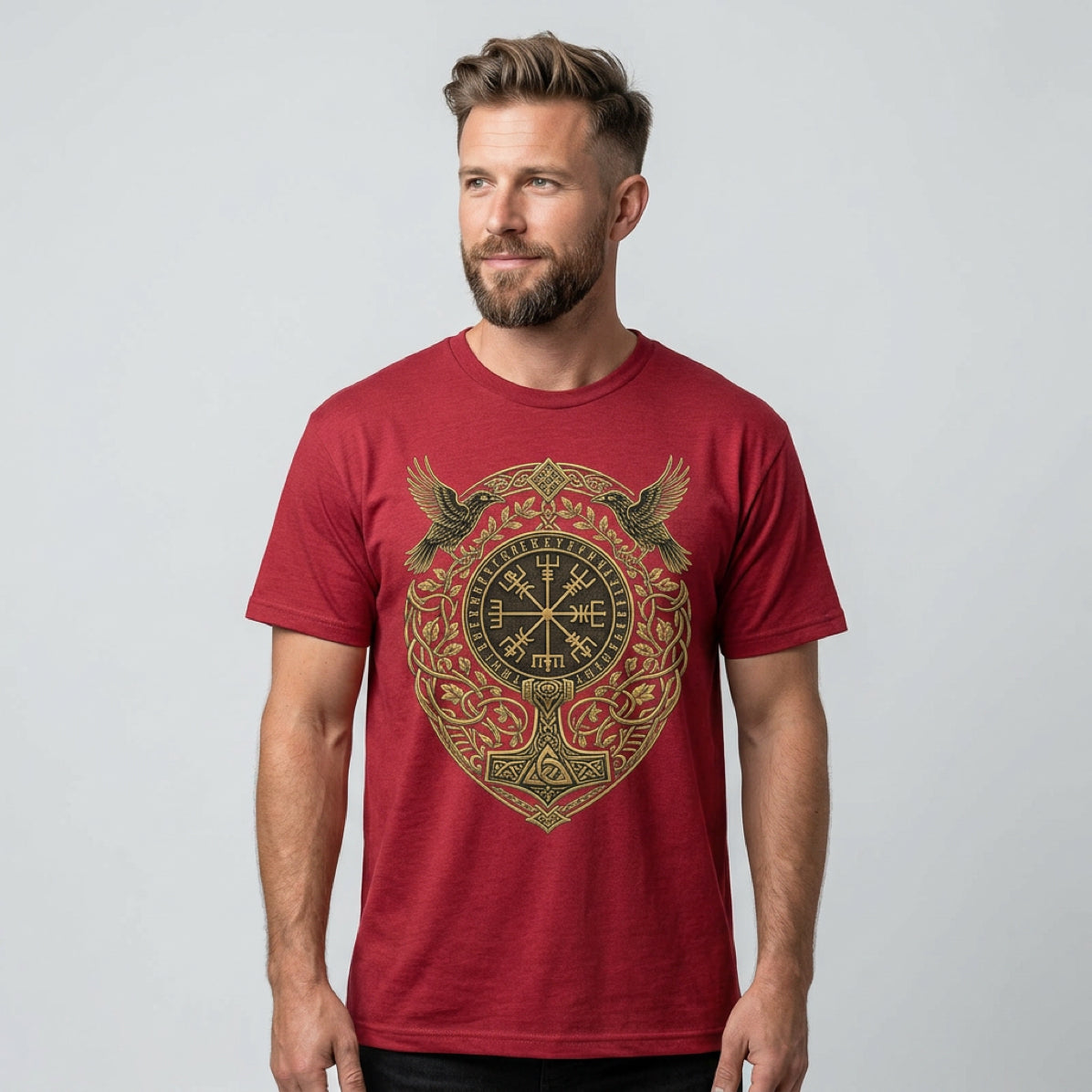 Man wearing a maroon t-shirt with a circular golden Norse knotwork design.