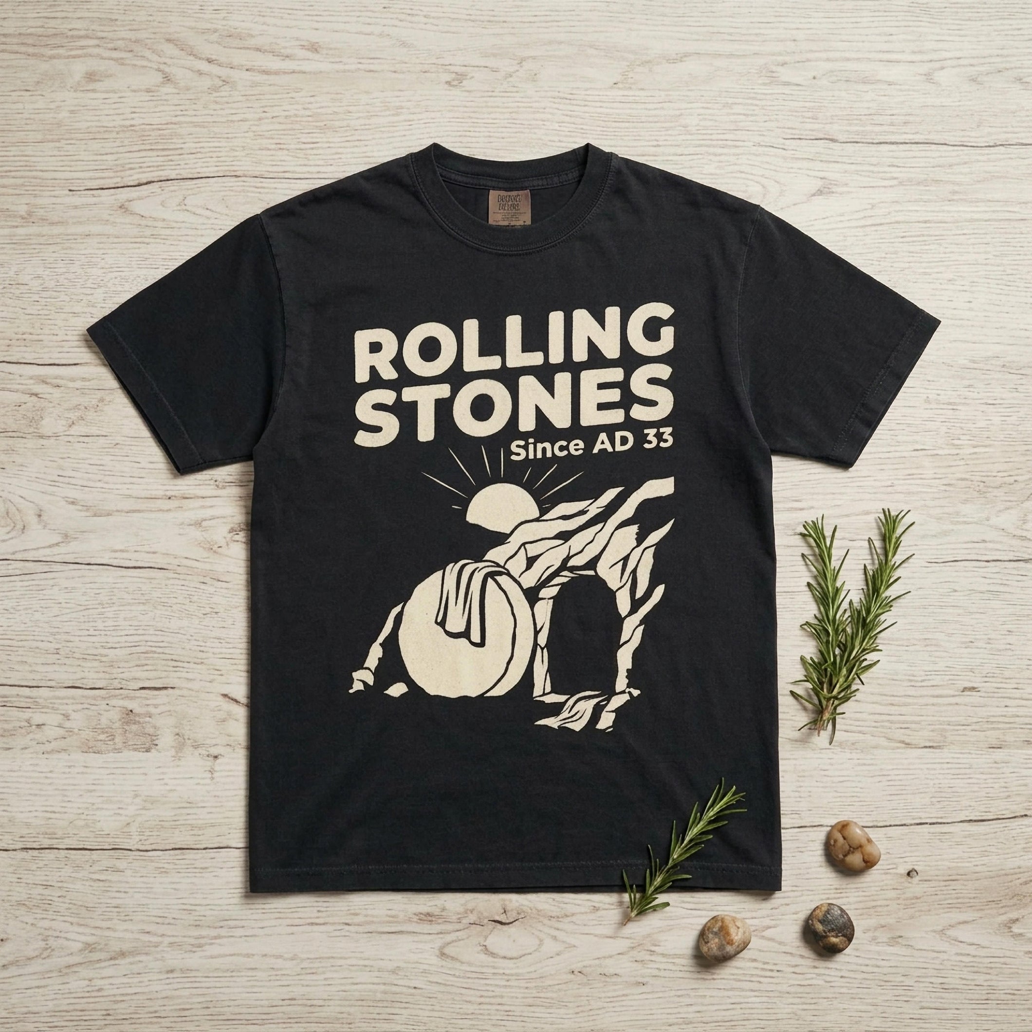 Black t-shirt with "ROLLING STONES Since AD 33" and tomb graphic.