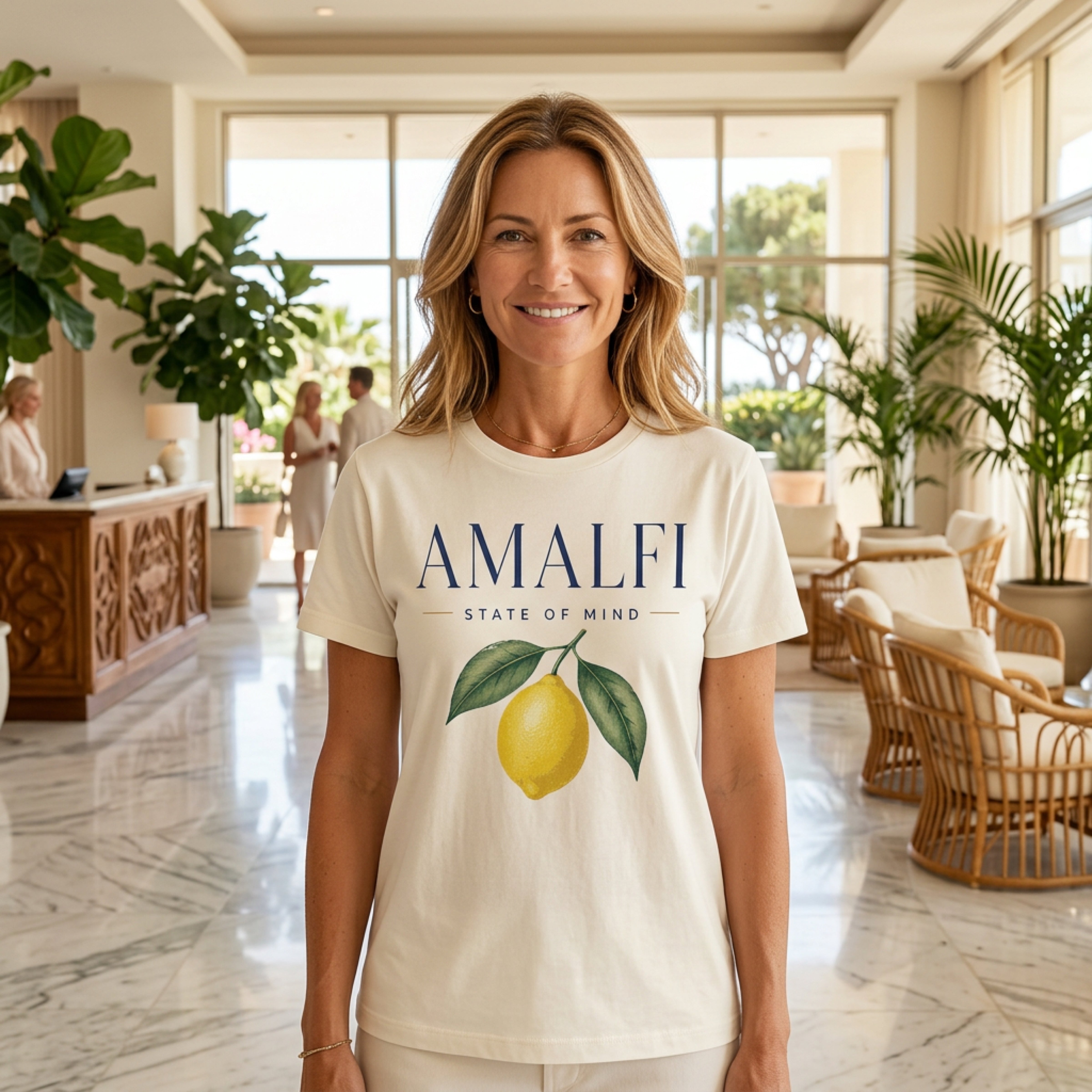 Woman wearing a cream t-shirt with "Amalfi State of Mind" and a lemon graphic.